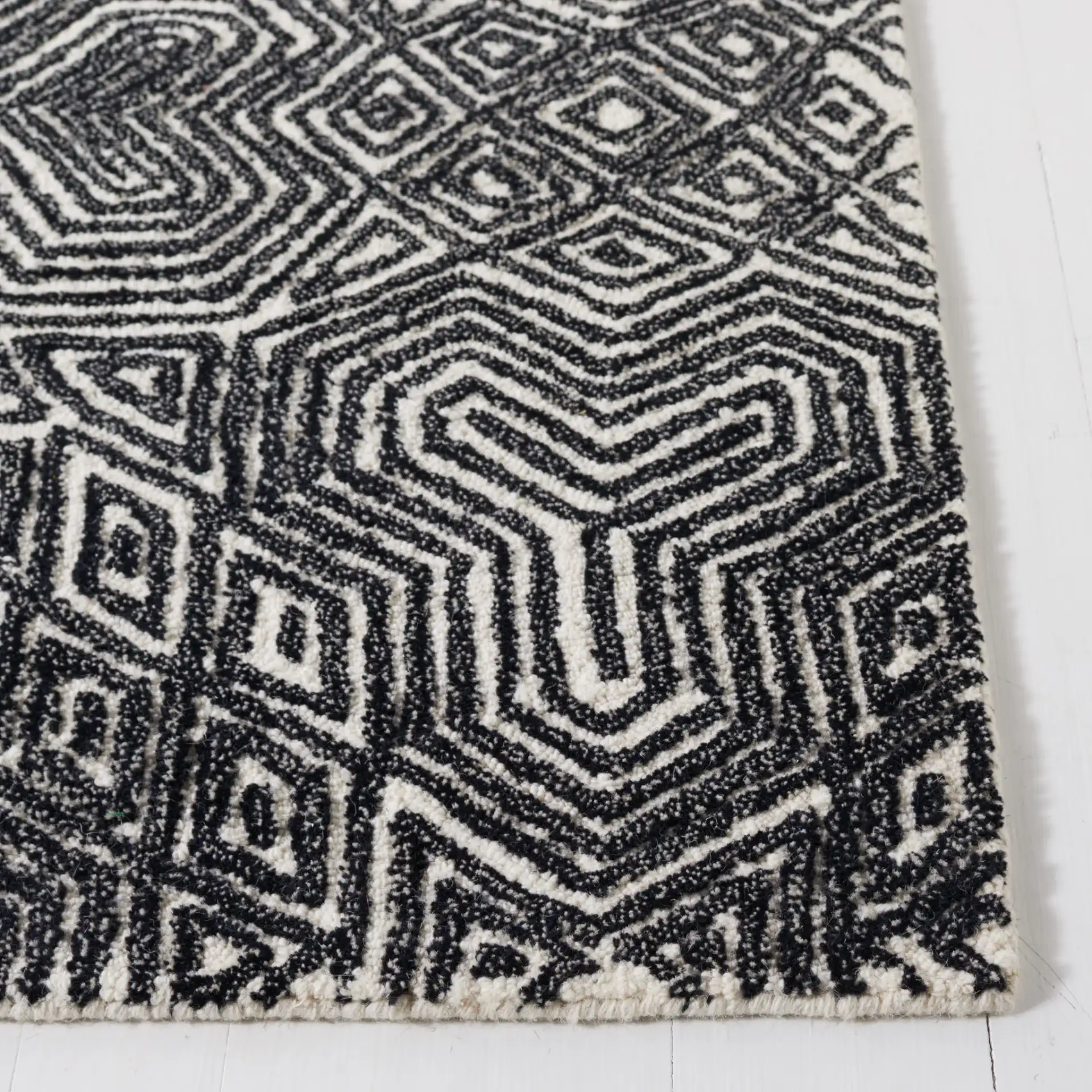 Micro-Loop Maze Hand-Tufted Wool Rug in Ivory / Black in a styled room