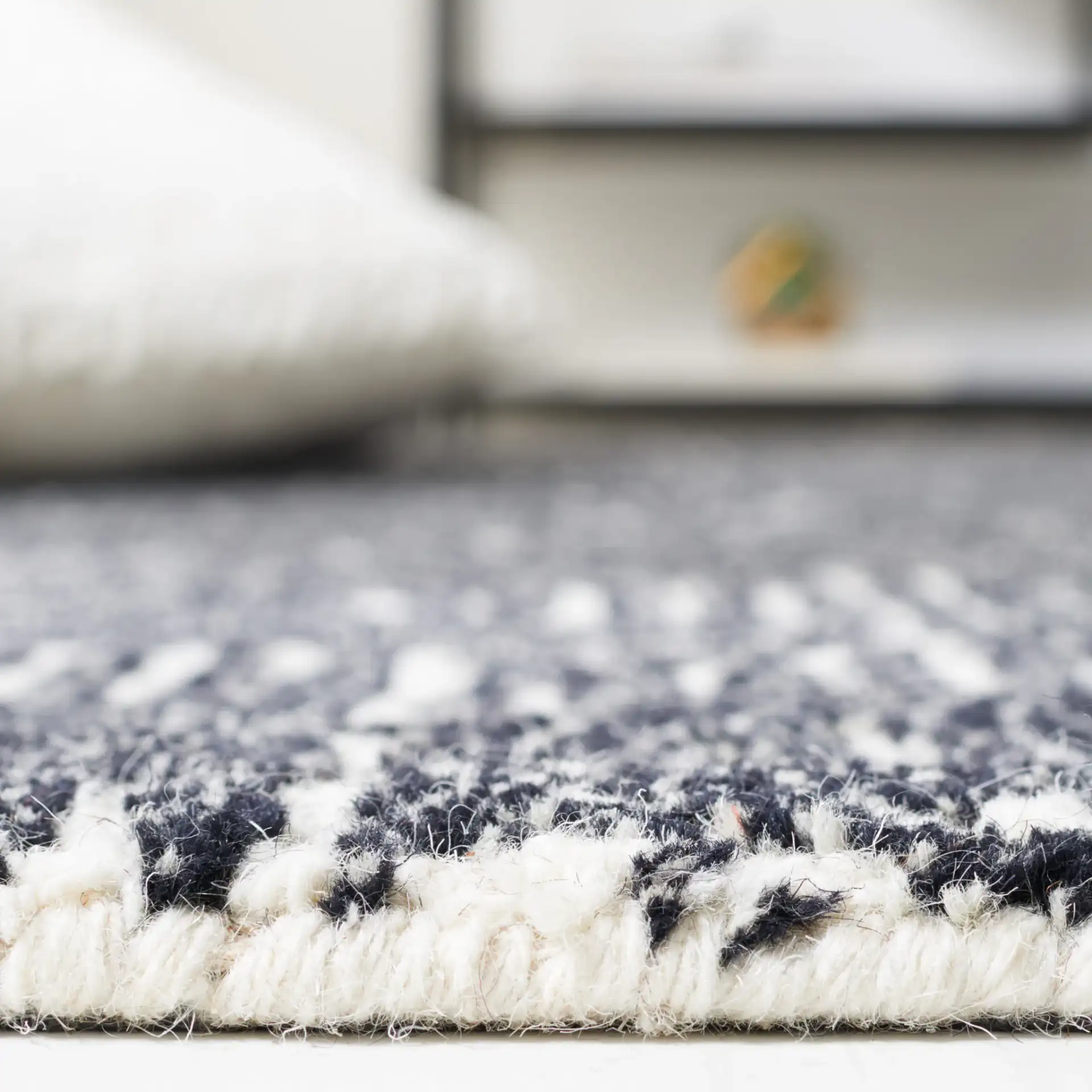 Micro-Loop Maze Hand-Tufted Wool Rug in Ivory / Black in a styled room