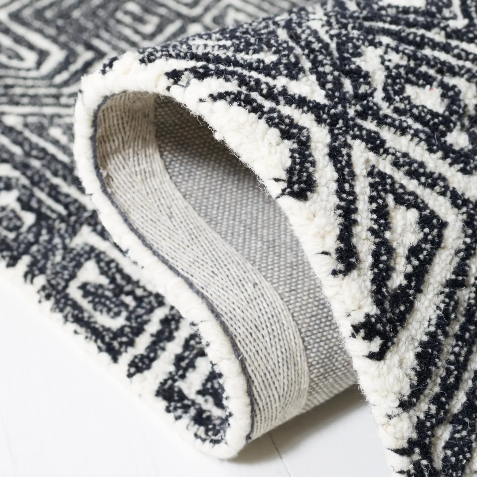 Micro-Loop Maze Hand-Tufted Wool Rug in Ivory / Black in a styled room