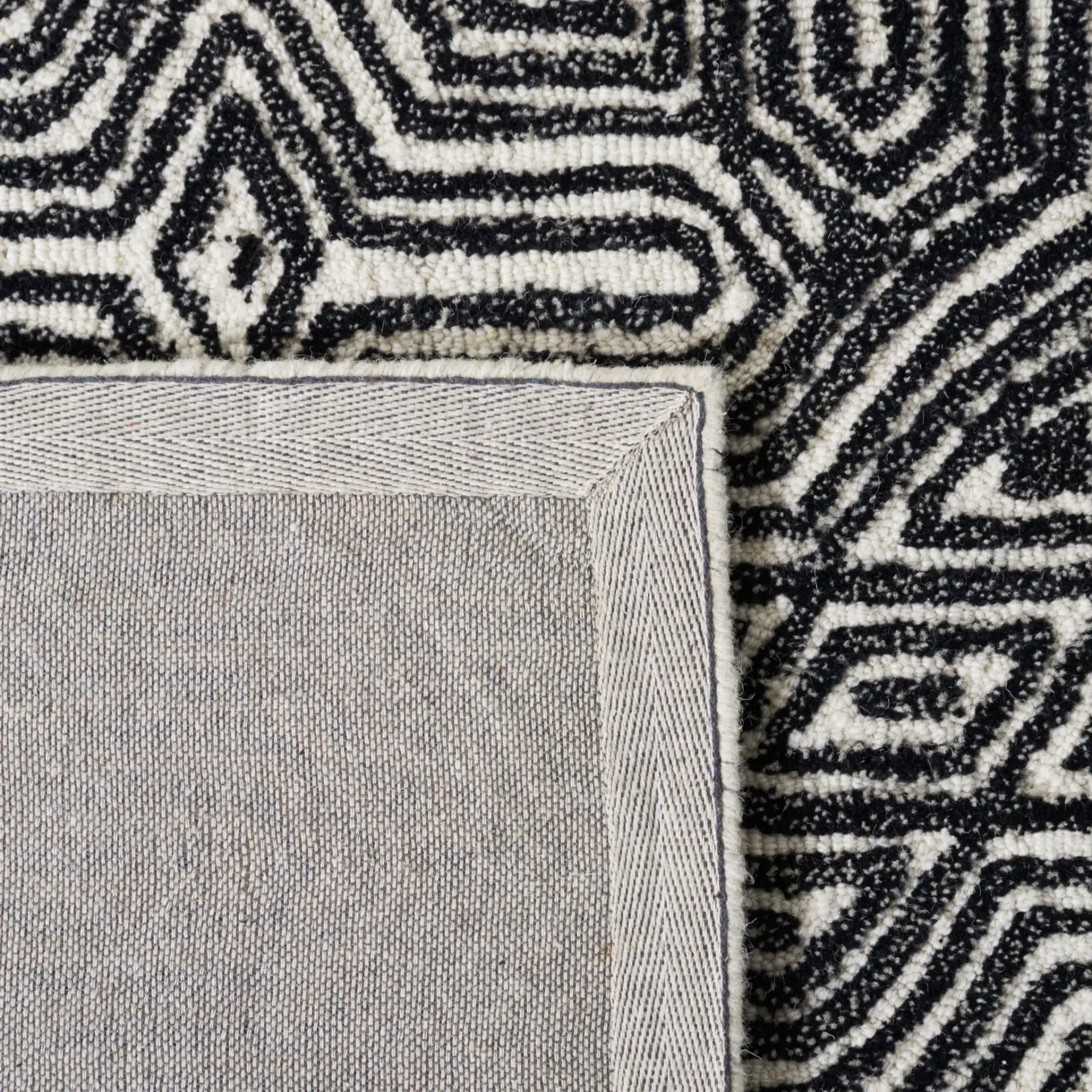 Micro-Loop Maze Hand-Tufted Wool Rug in Ivory / Black in a styled room