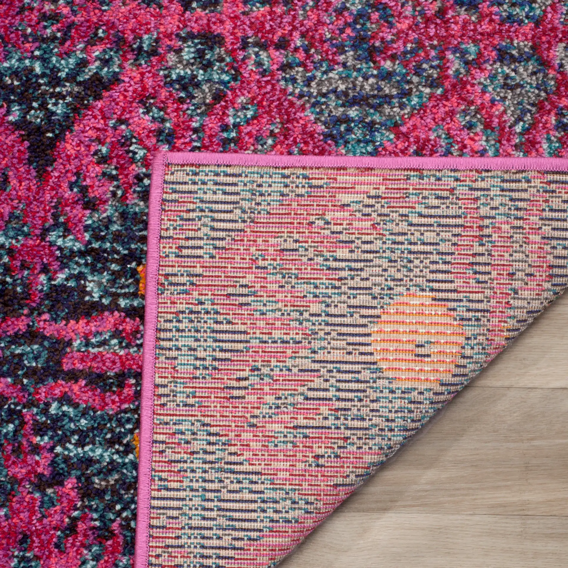 Monaco Tribal Diamond Rug in Pink / Multicolor in a styled room