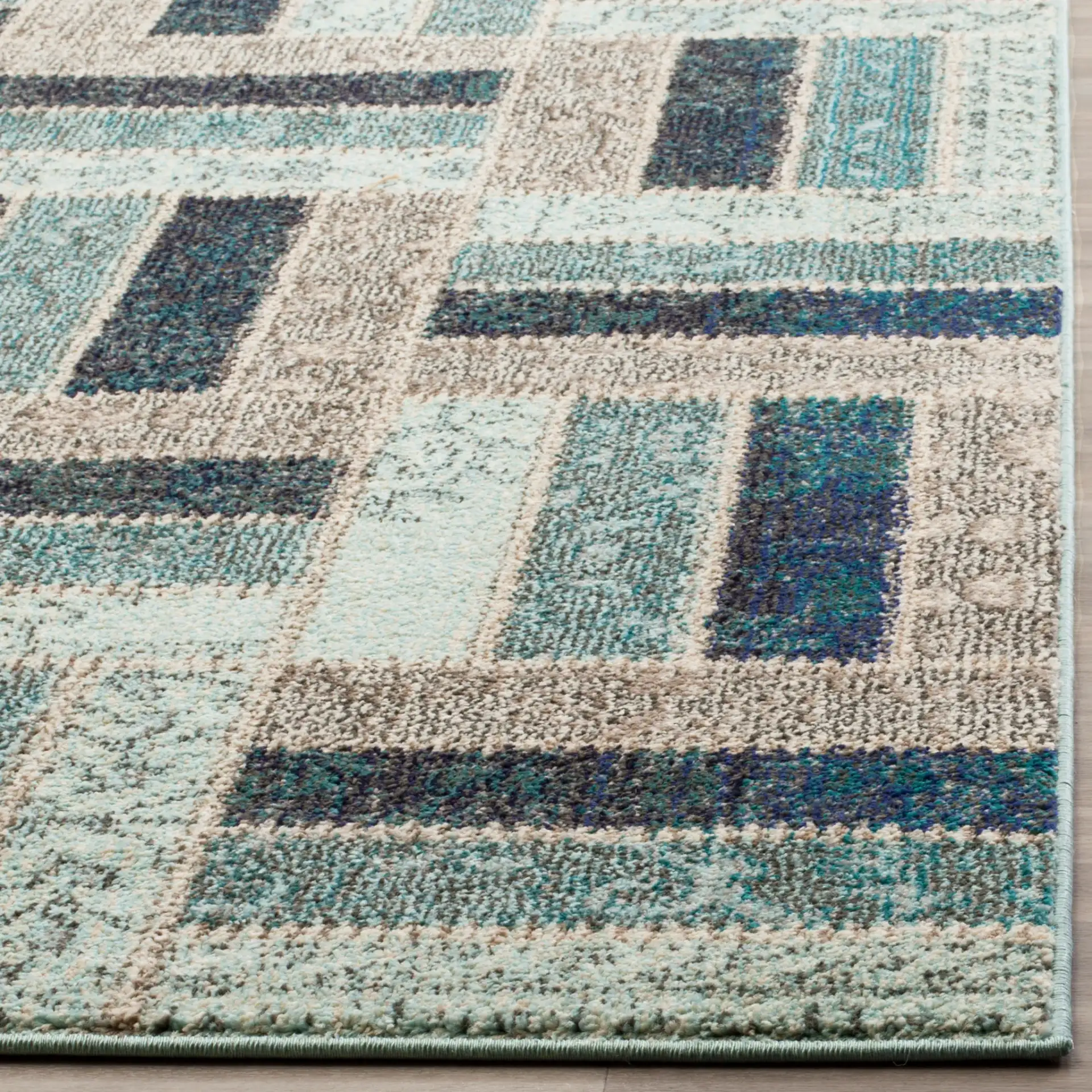 Monaco Patchwork Block Rug in Gray / Blue in a styled room