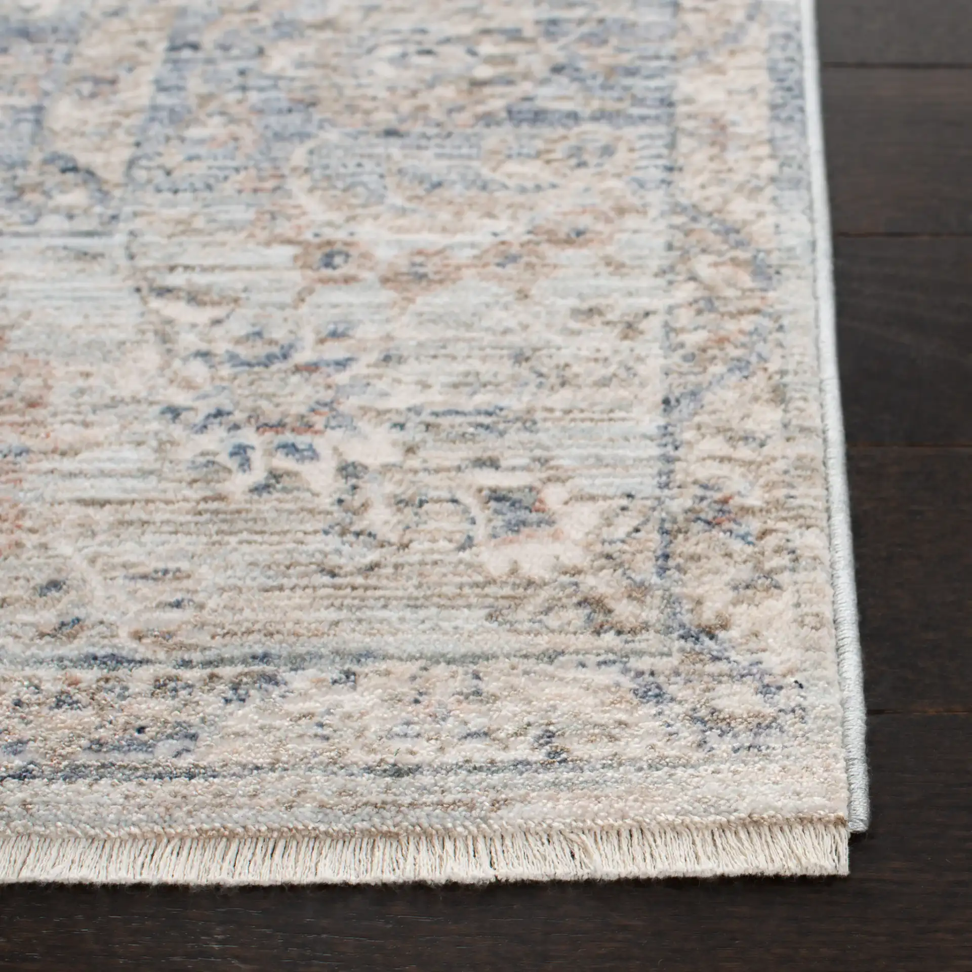 Moondust Faded Floral Bordered Rug in Beige / Gray in a styled room