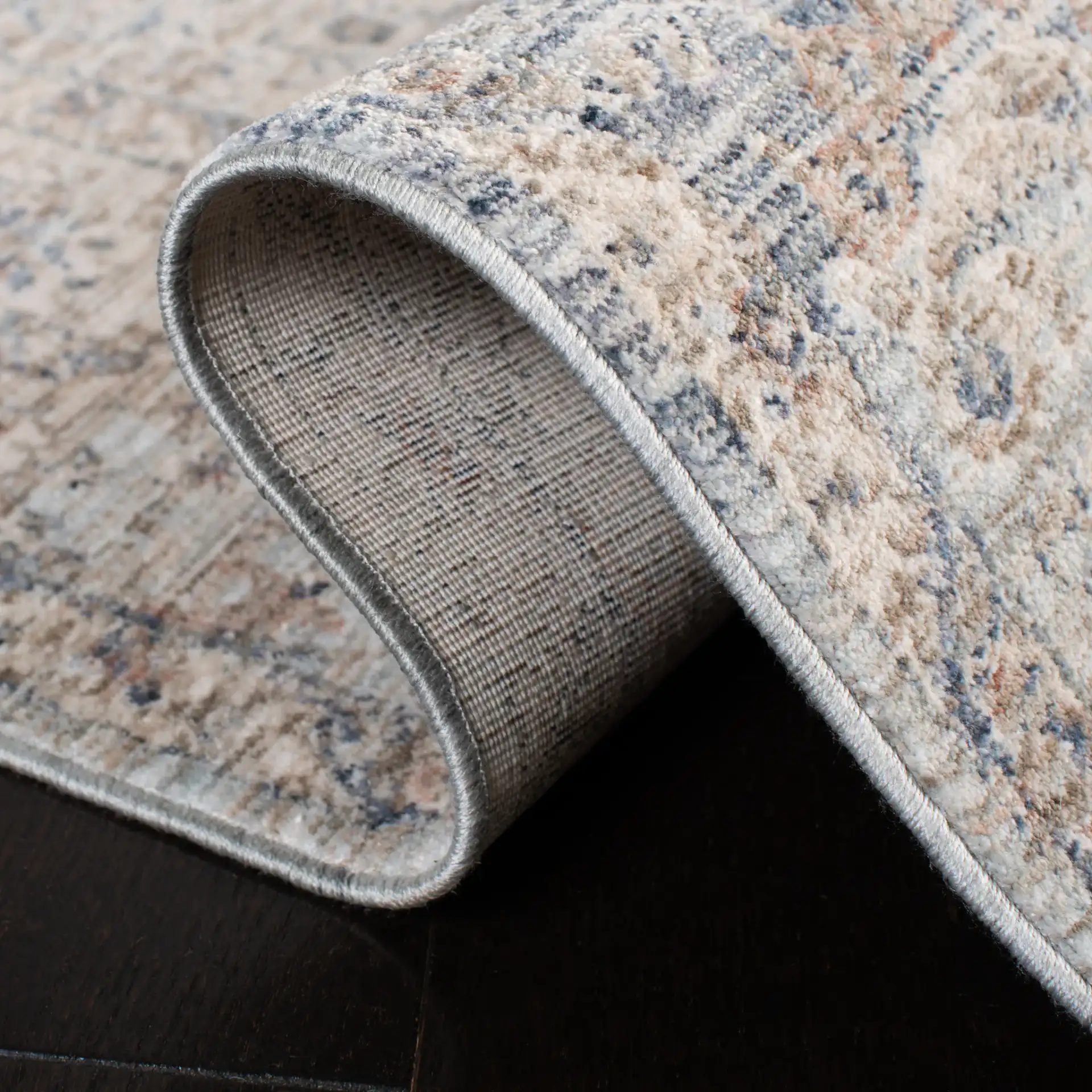 Moondust Faded Floral Bordered Rug in Beige / Gray in a styled room