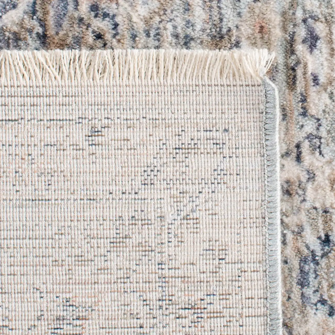 Moondust Faded Floral Bordered Rug in Beige / Gray in a styled room