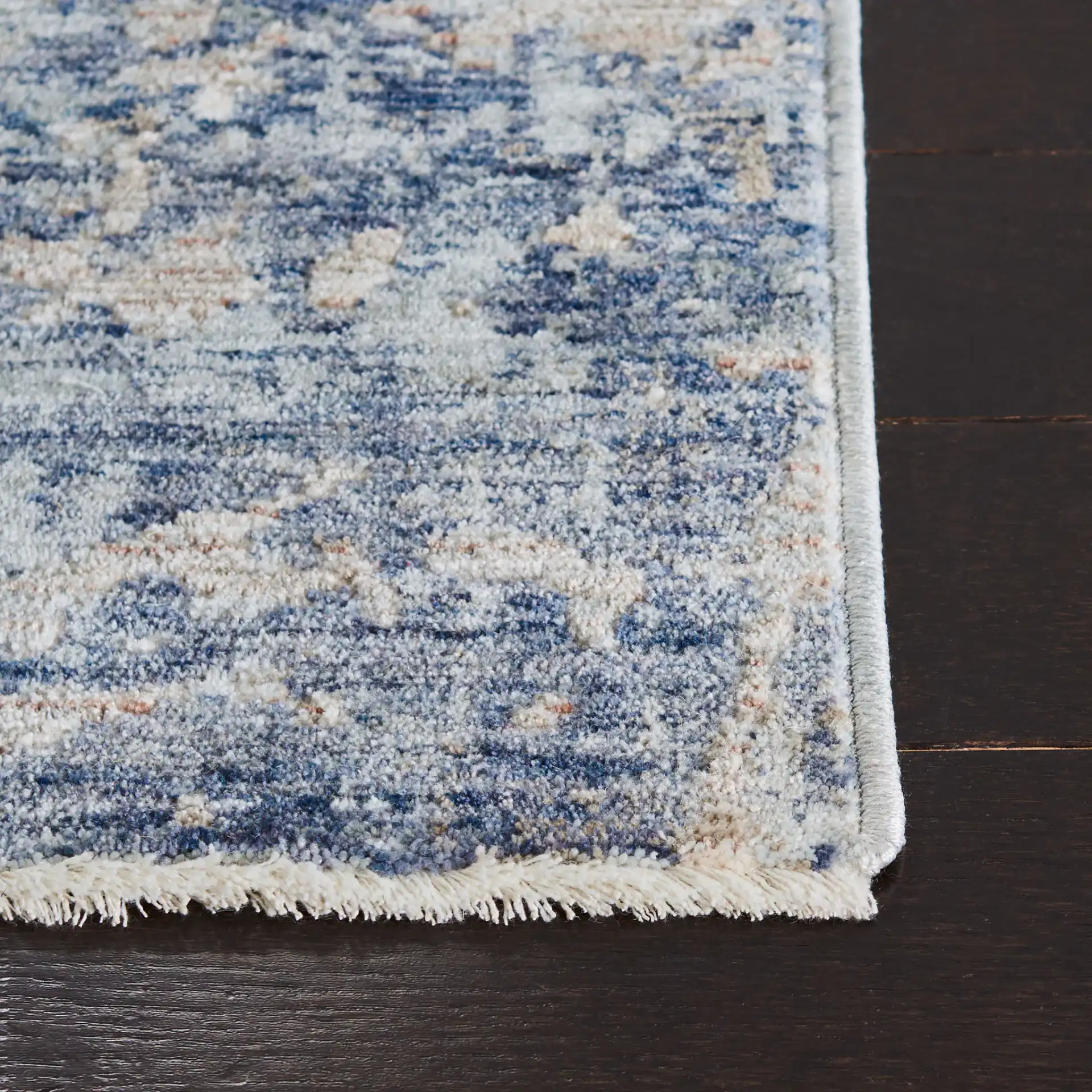 Moondust Textured Abstract Rug in Gray / Blue in a styled room