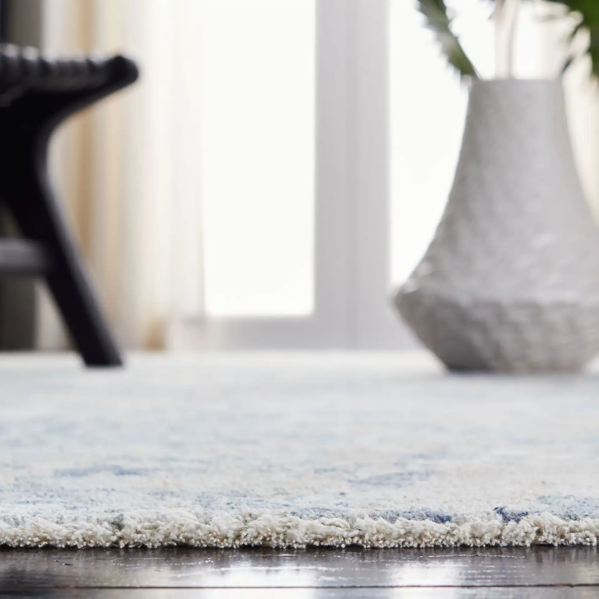 Moondust Textured Abstract Rug in Gray / Blue in a styled room