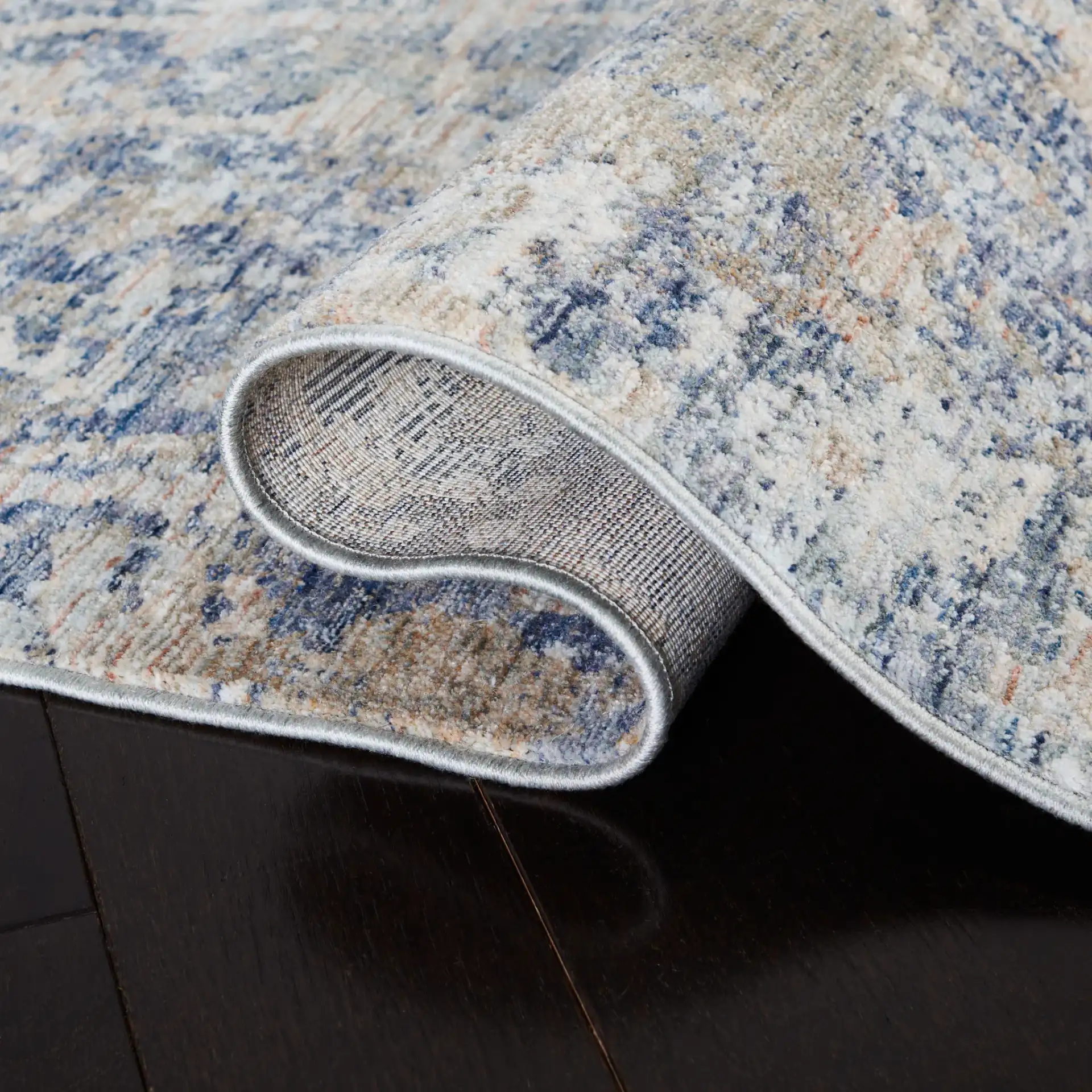 Moondust Textured Abstract Rug in Gray / Blue in a styled room