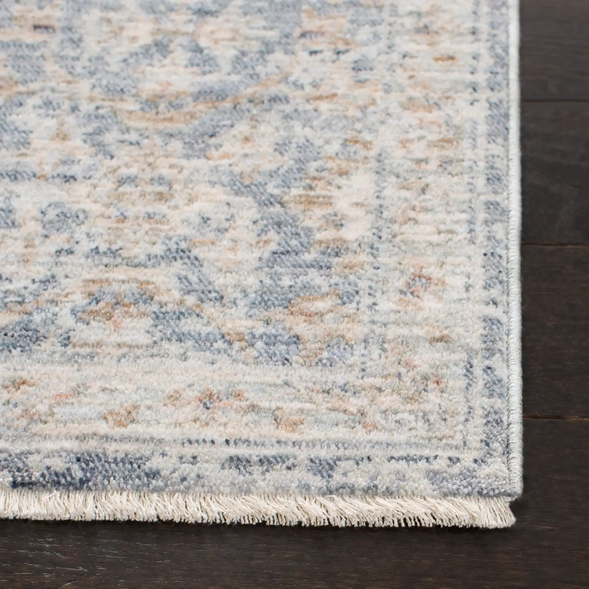 Moondust Distressed Rosette Rug in Blue / Ivory in a styled room