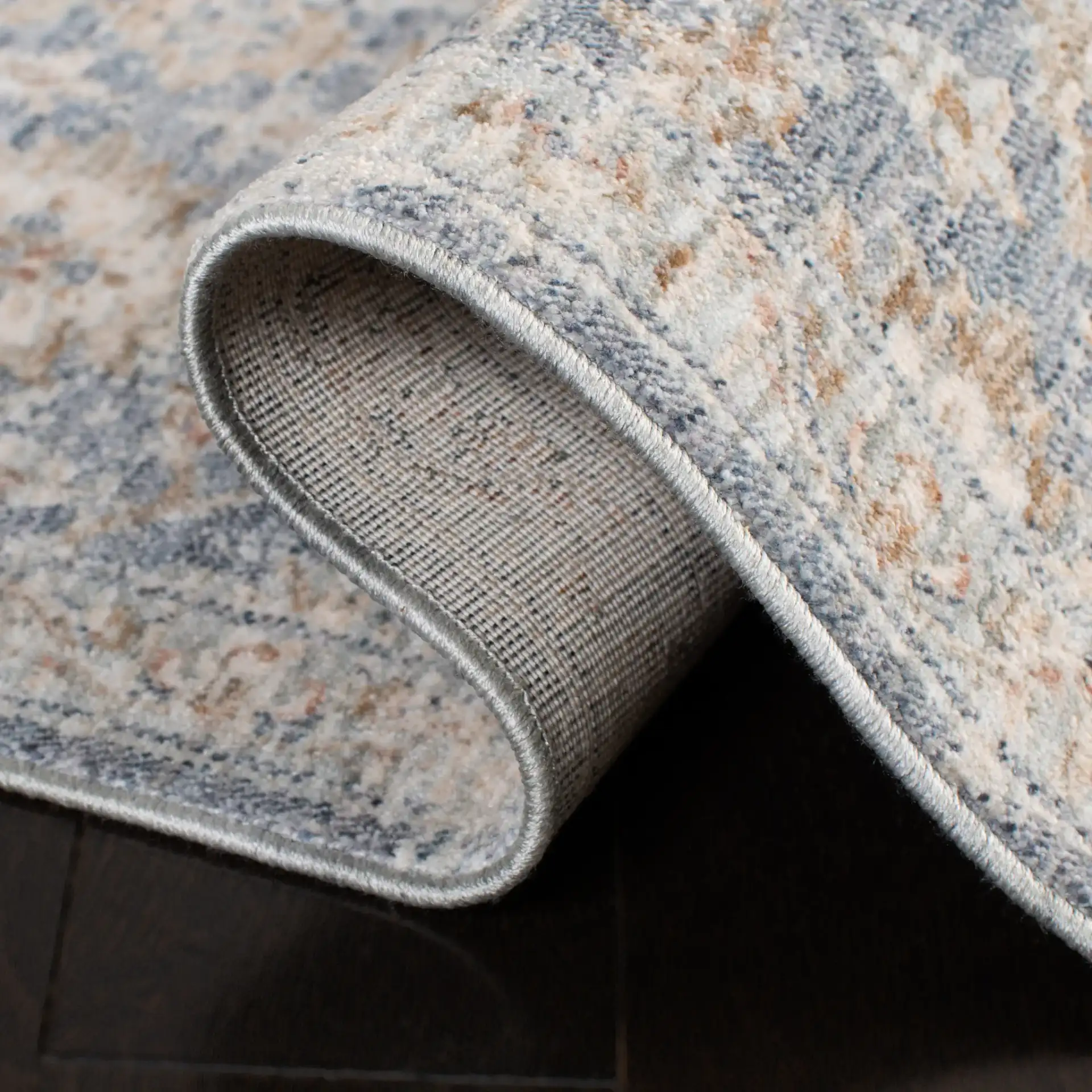Moondust Distressed Rosette Rug in Blue / Ivory in a styled room
