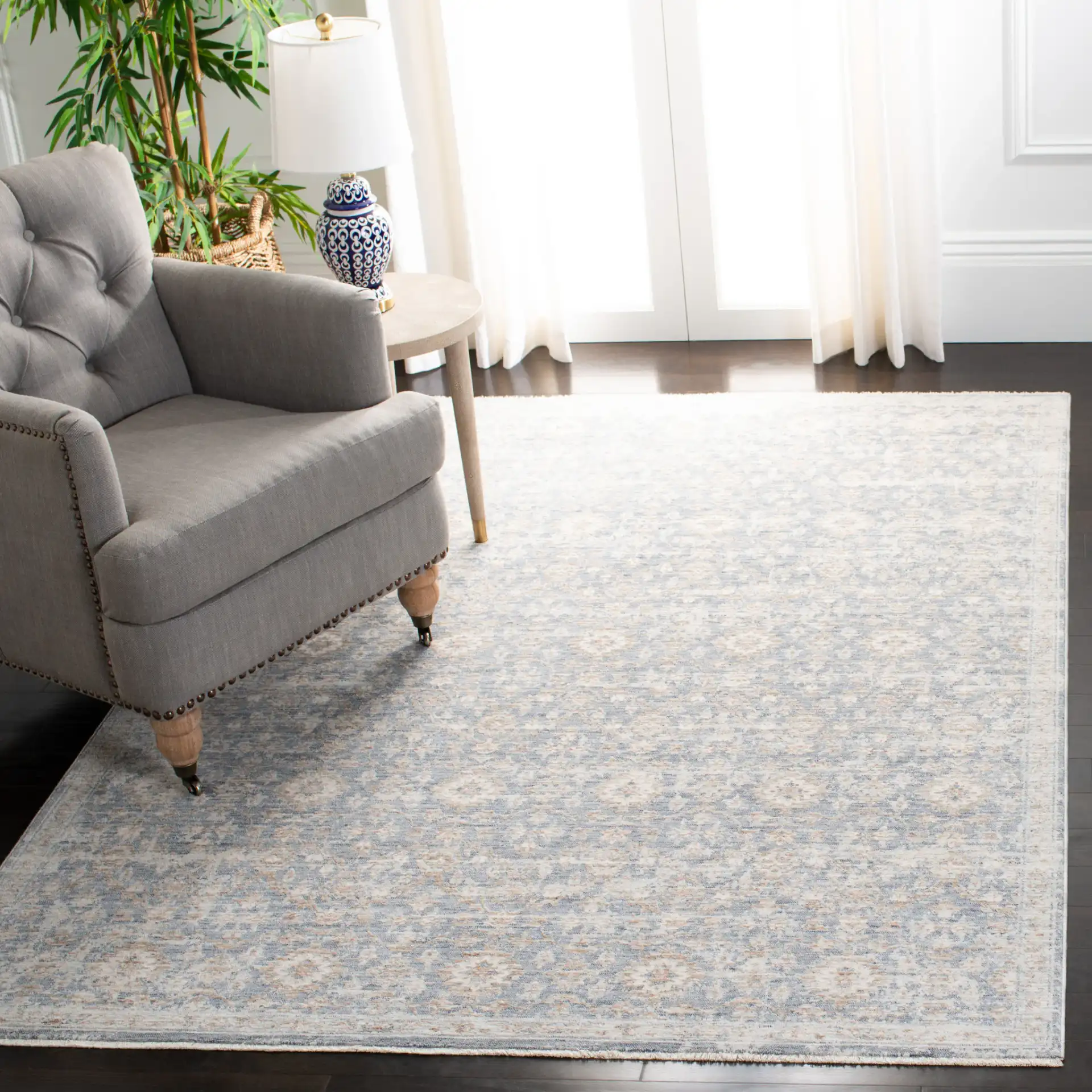 Moondust Distressed Rosette Rug in Blue / Ivory in a styled room