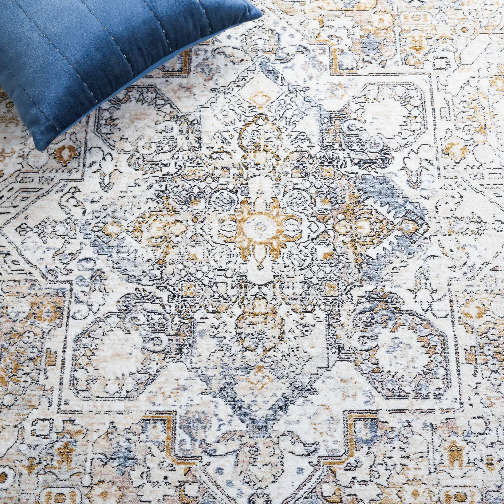 Moondust Distressed Medallion Rug in Ivory / Blue in a styled room
