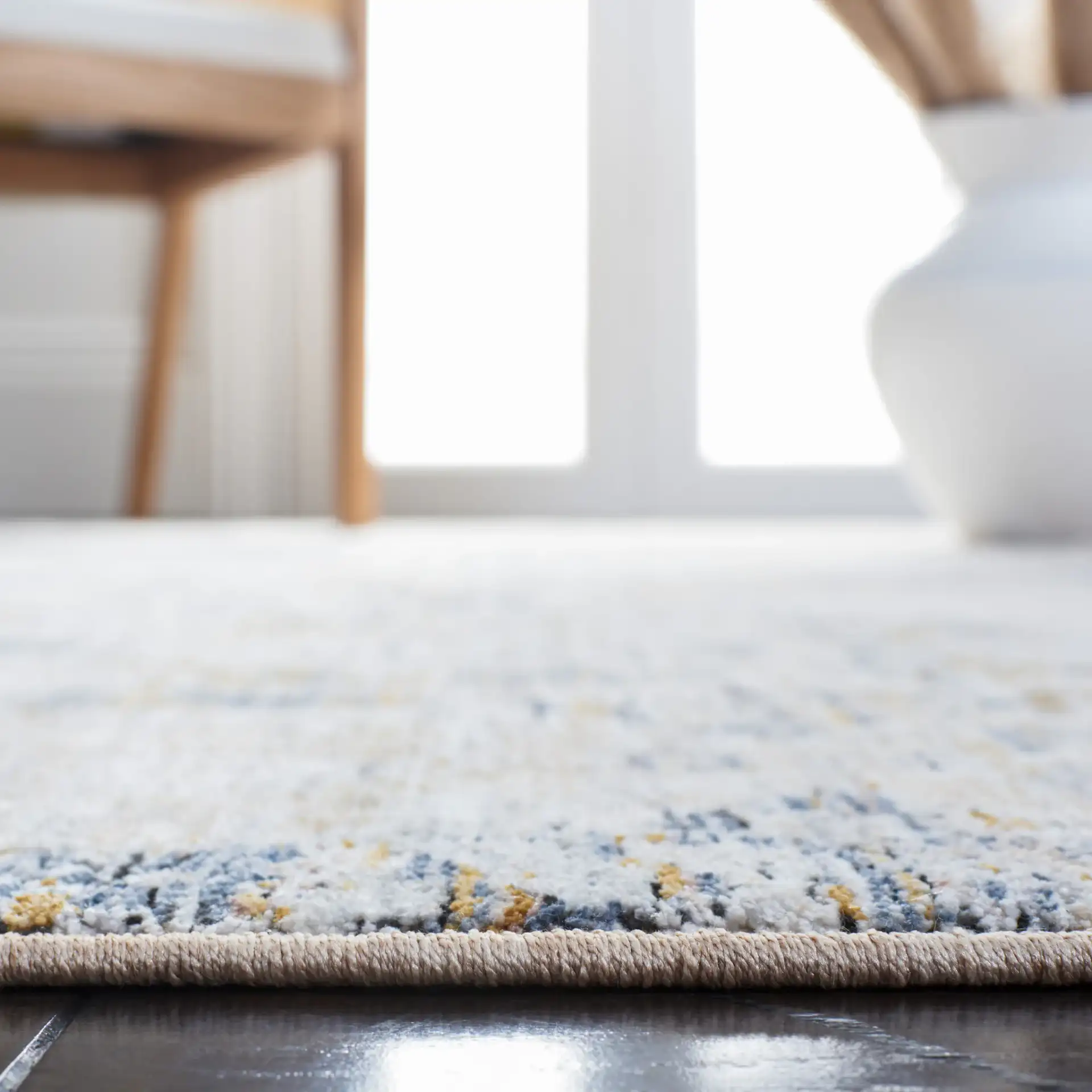 Moondust Distressed Damask Rug in Gray / Blue in a styled room