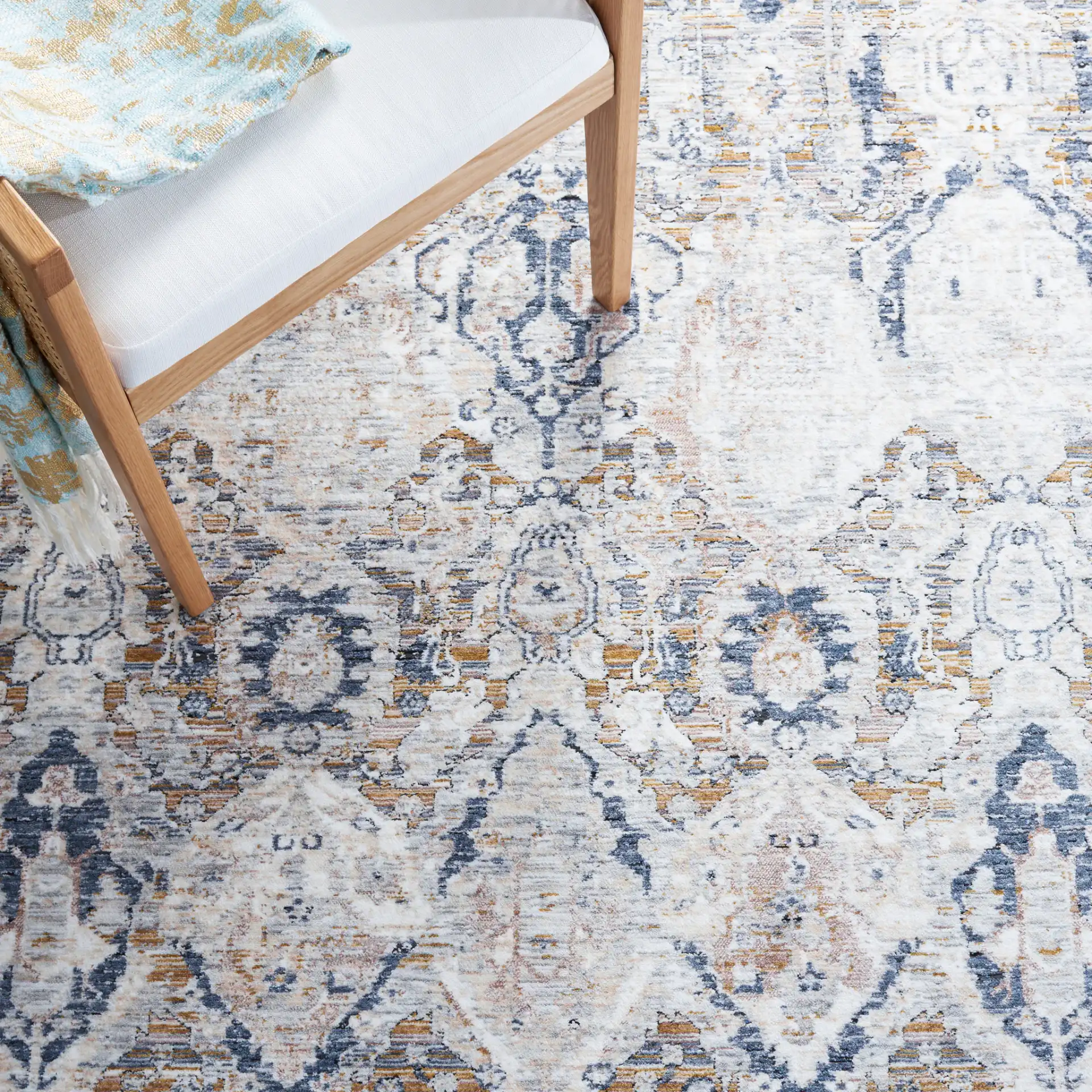 Moondust Distressed Damask Rug in Gray / Blue in a styled room