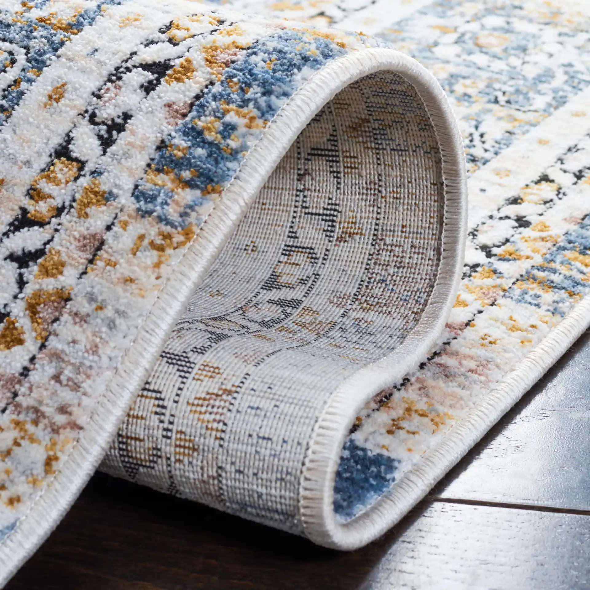 Moondust Distressed Banded Floral Rug in Blue / Gray in a styled room