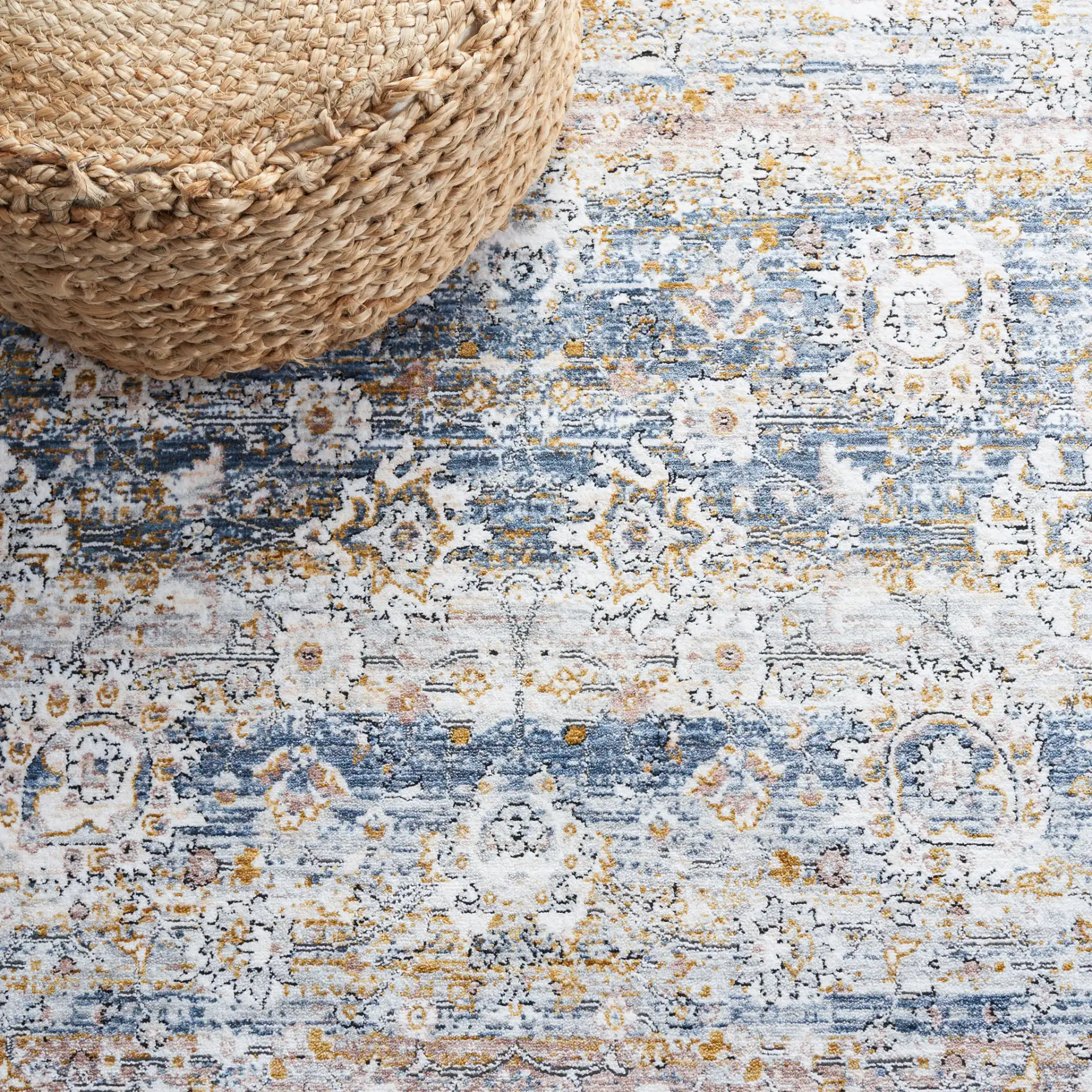Moondust Distressed Banded Floral Rug in Blue / Gray in a styled room