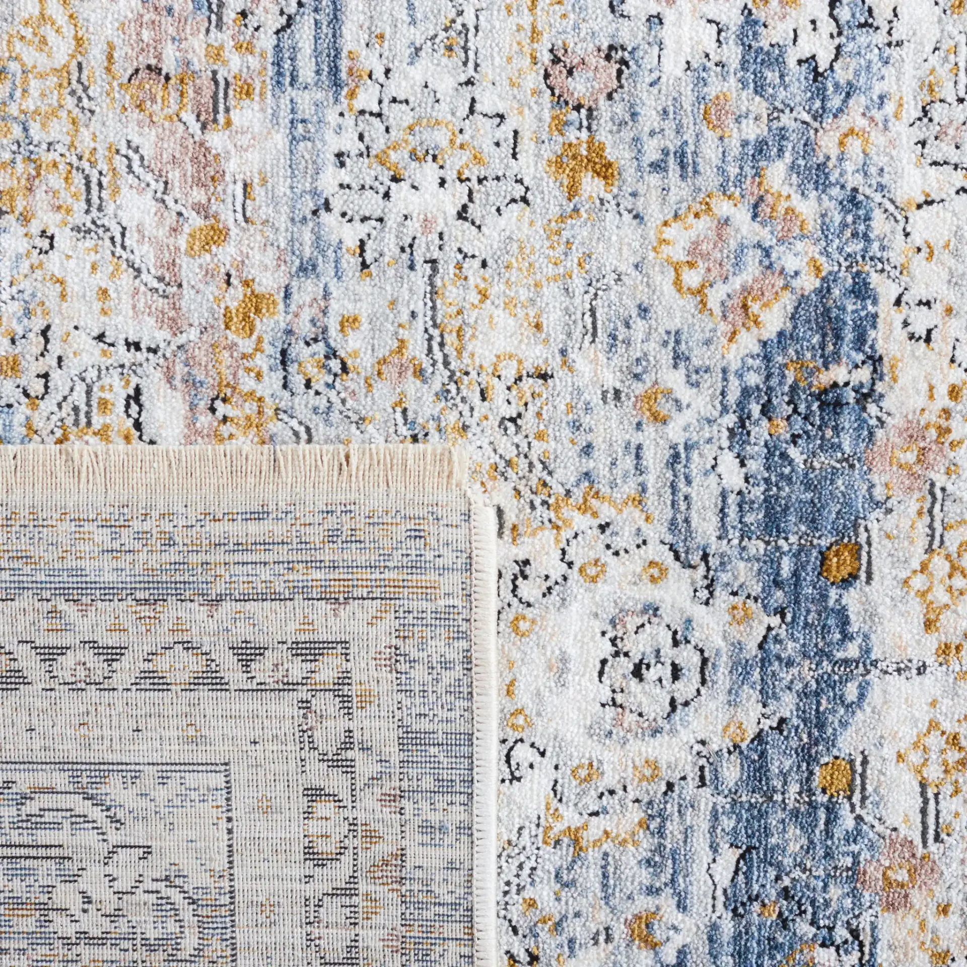 Moondust Distressed Banded Floral Rug in Blue / Gray in a styled room