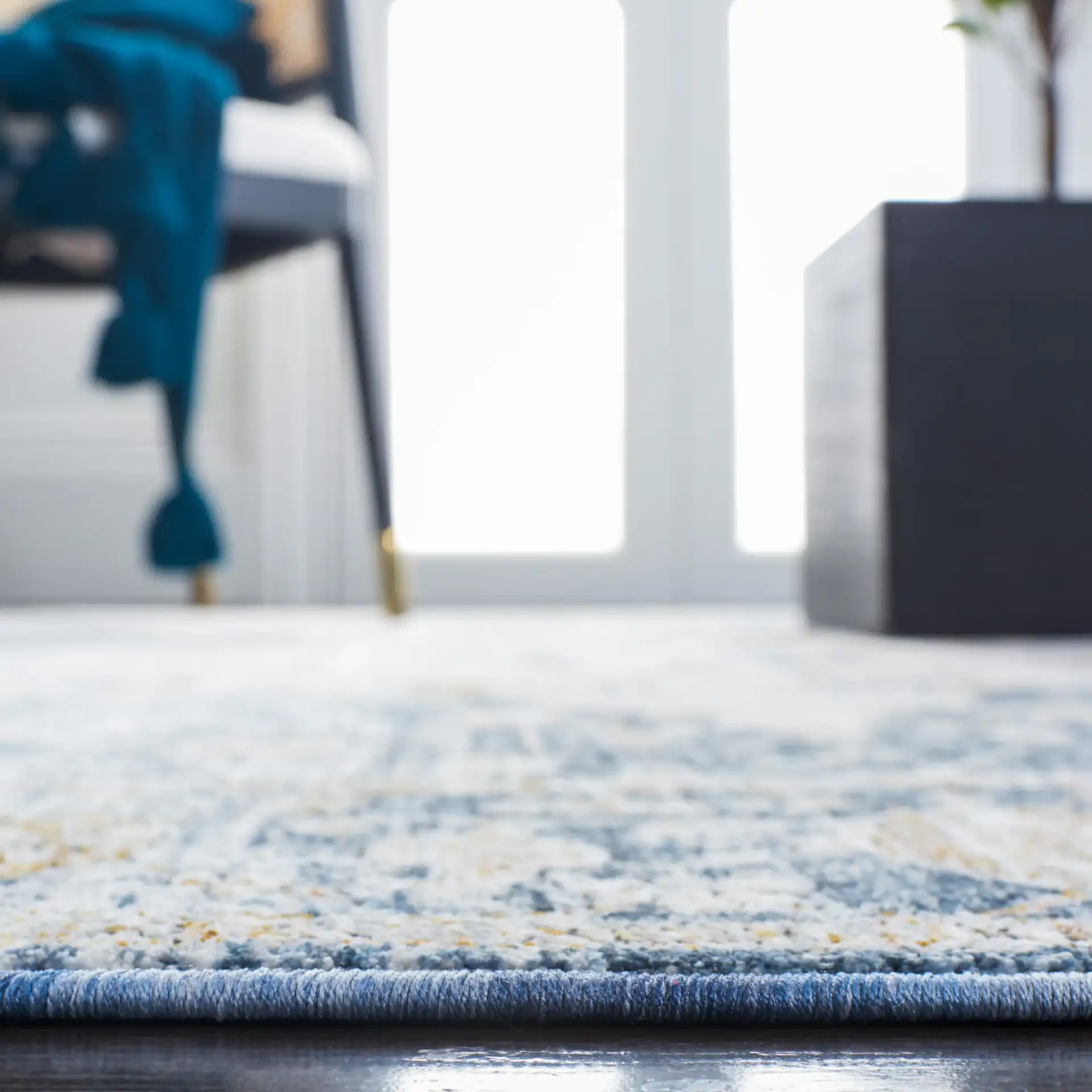 Moondust Distressed Traditional Medallion Rug in Ivory / Blue in a styled room