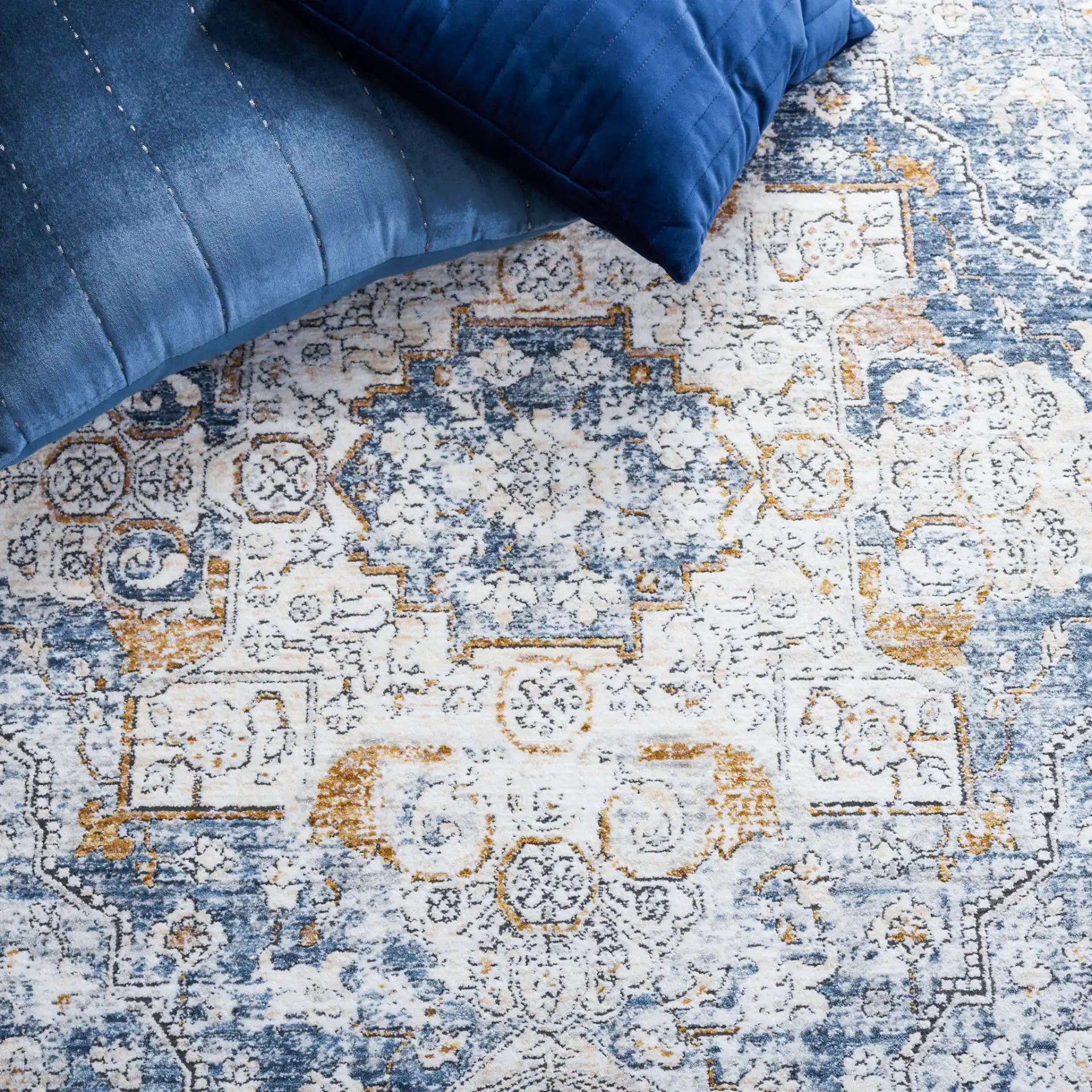 Moondust Distressed Traditional Medallion Rug in Ivory / Blue in a styled room