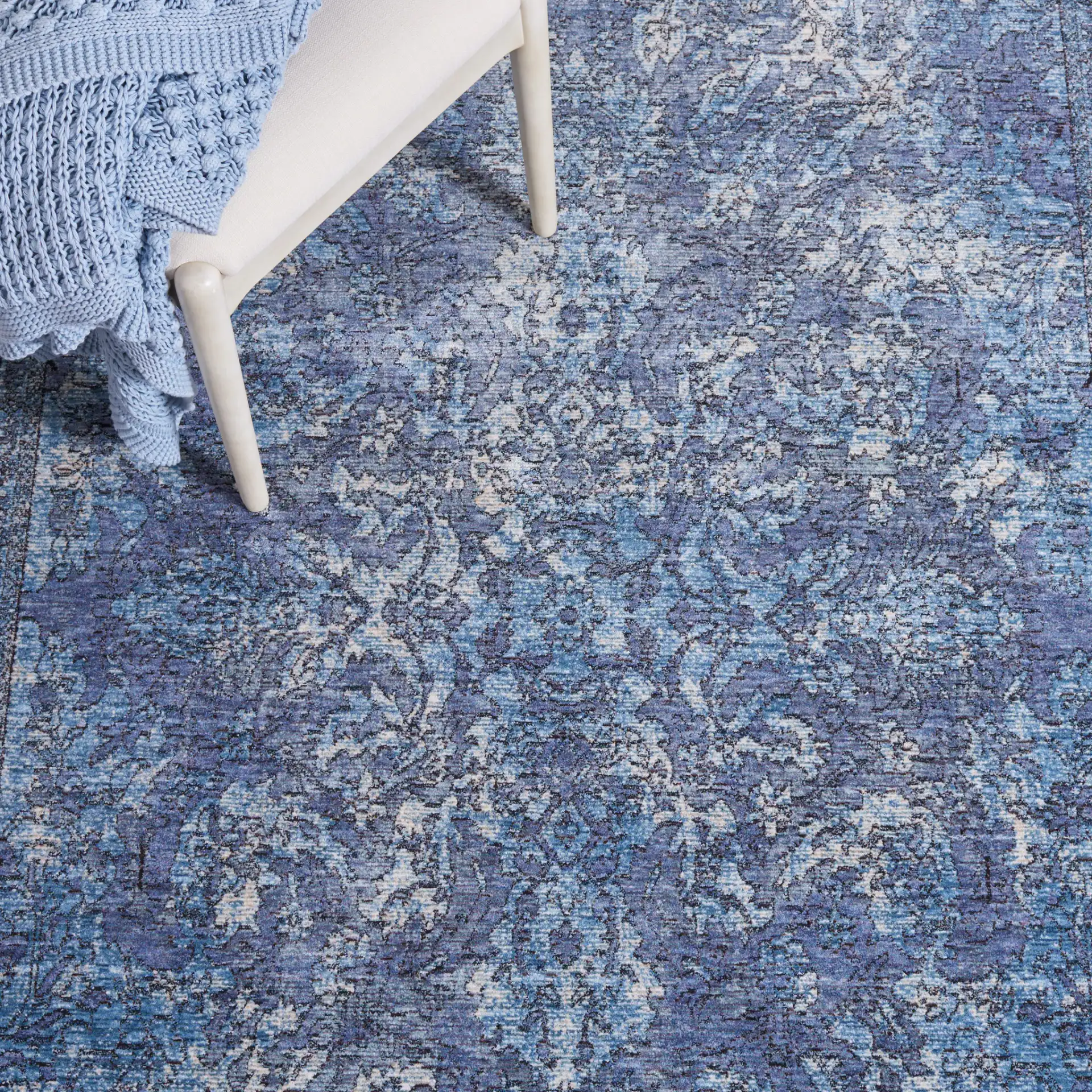 Moondust Distressed Arabesque Rug in Blue / Turquoise in a styled room