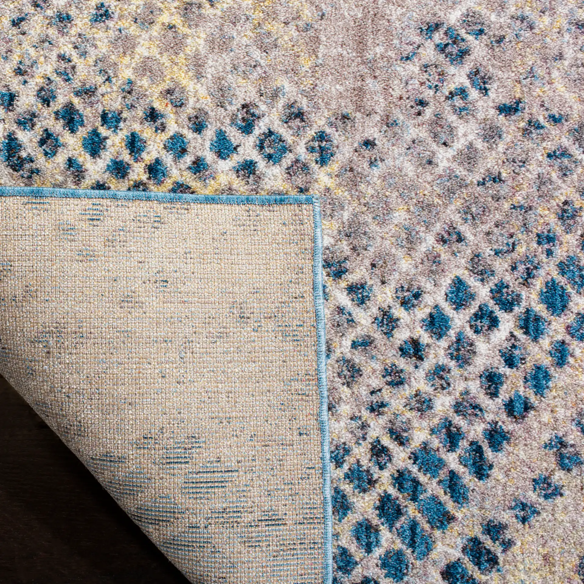 Monray Distressed Grid Rug in Blue / Multicolor in a styled room