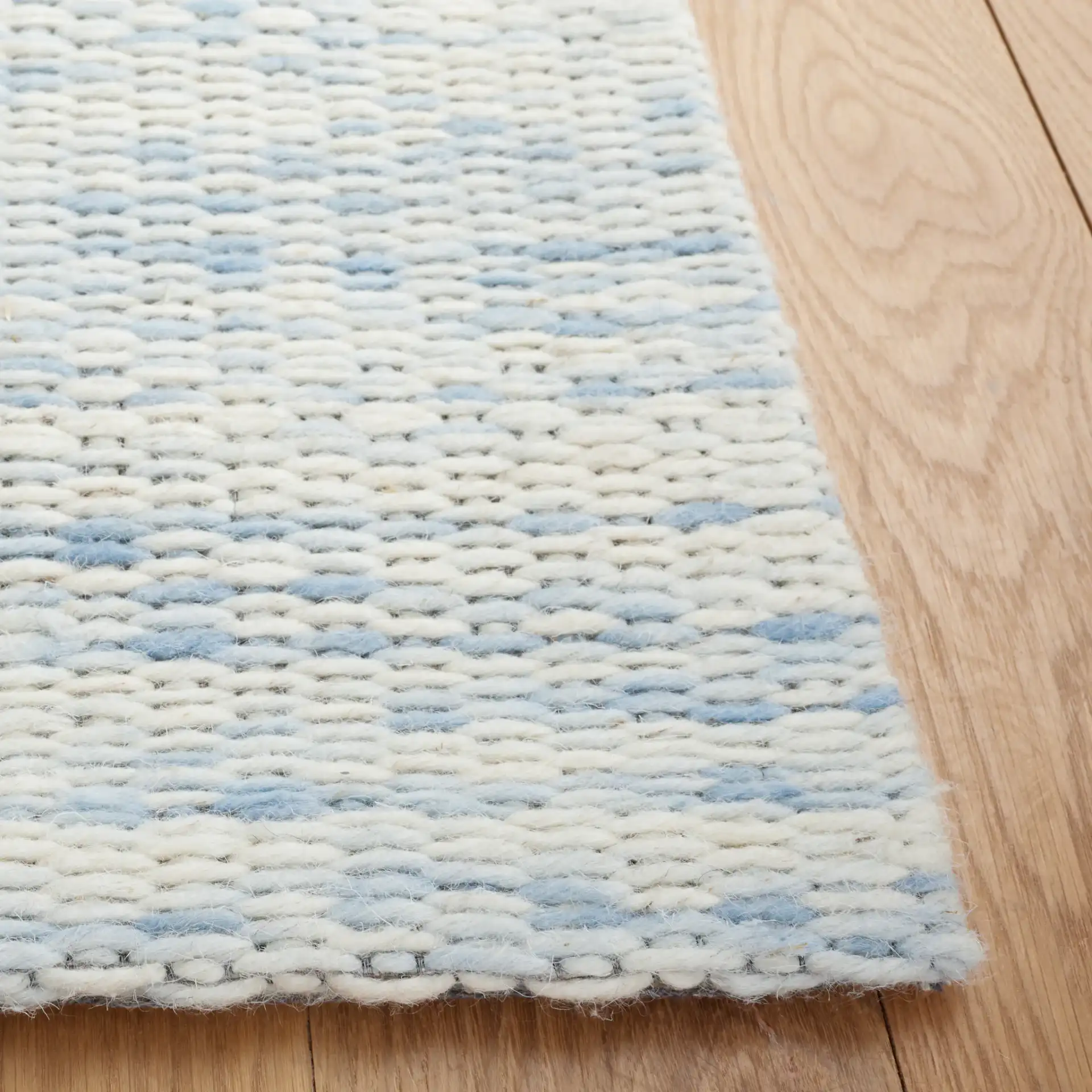 Marbella Striated Hand-Woven Wool Rug in Blue / Ivory in a styled room