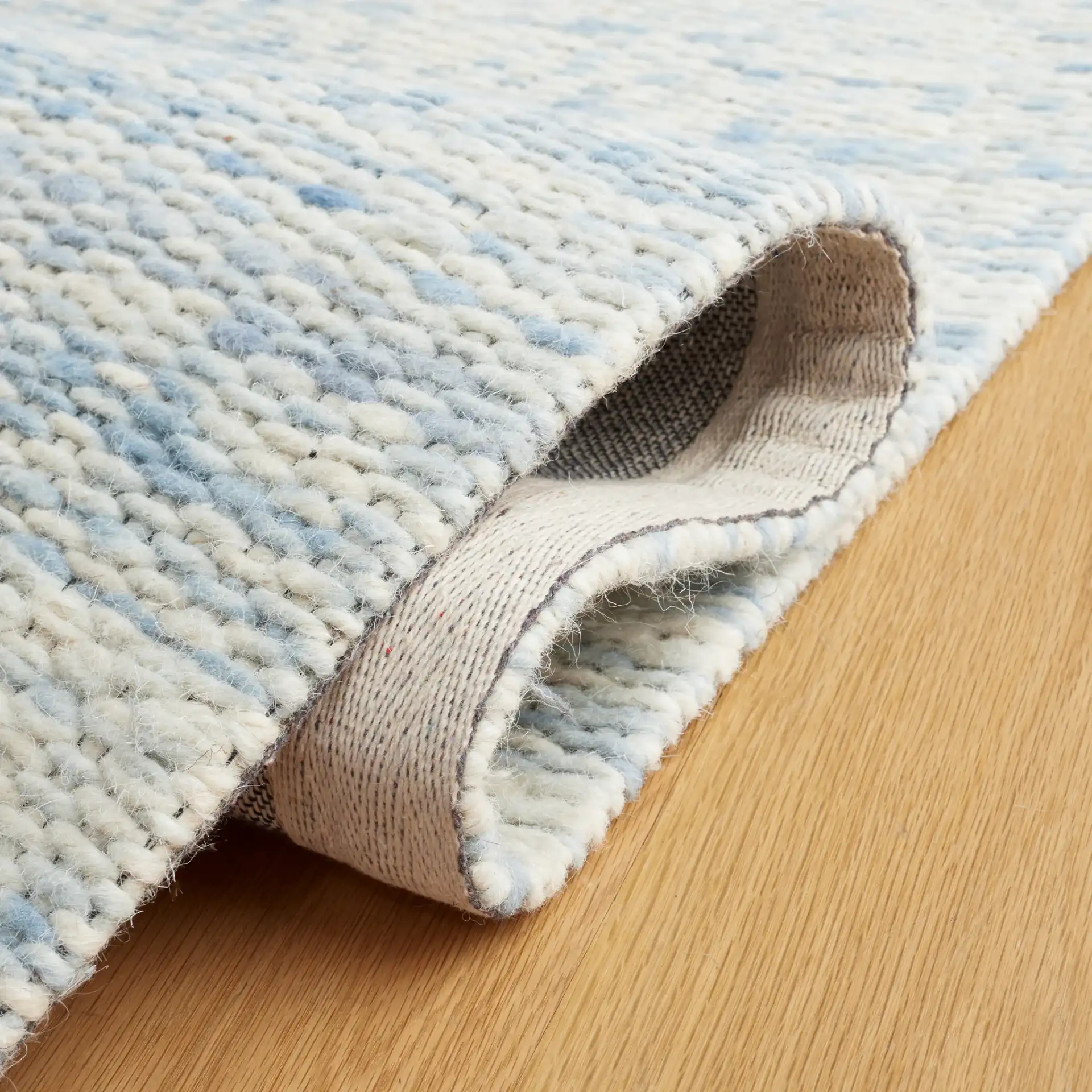 Marbella Striated Hand-Woven Wool Rug in Blue / Ivory in a styled room