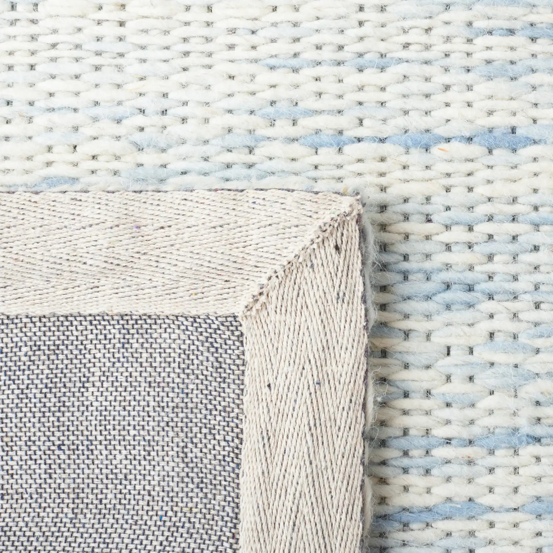 Marbella Striated Hand-Woven Wool Rug in Blue / Ivory in a styled room