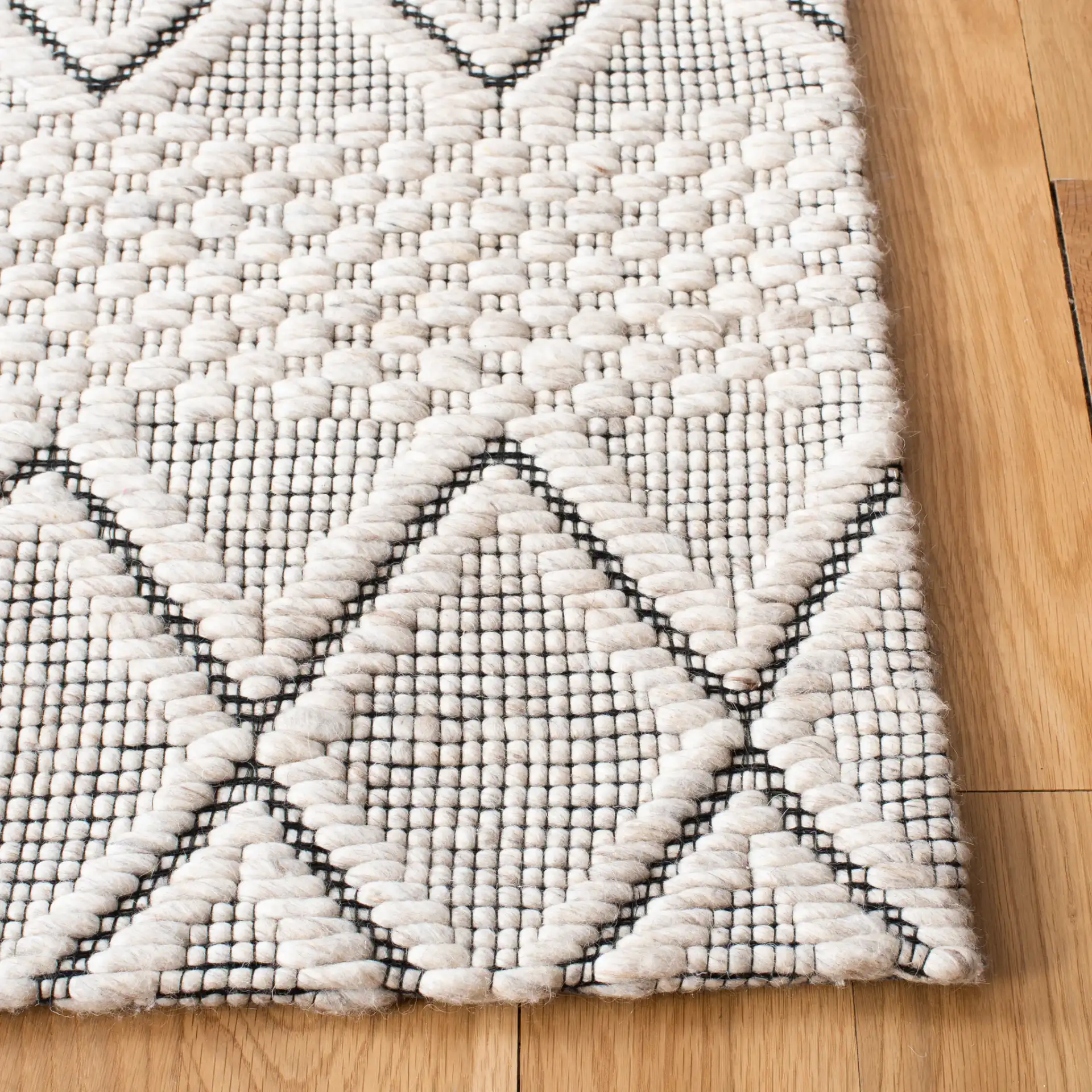 Marbella Banded Diamond Hand-Woven Wool Rug in Silver / Black in a styled room