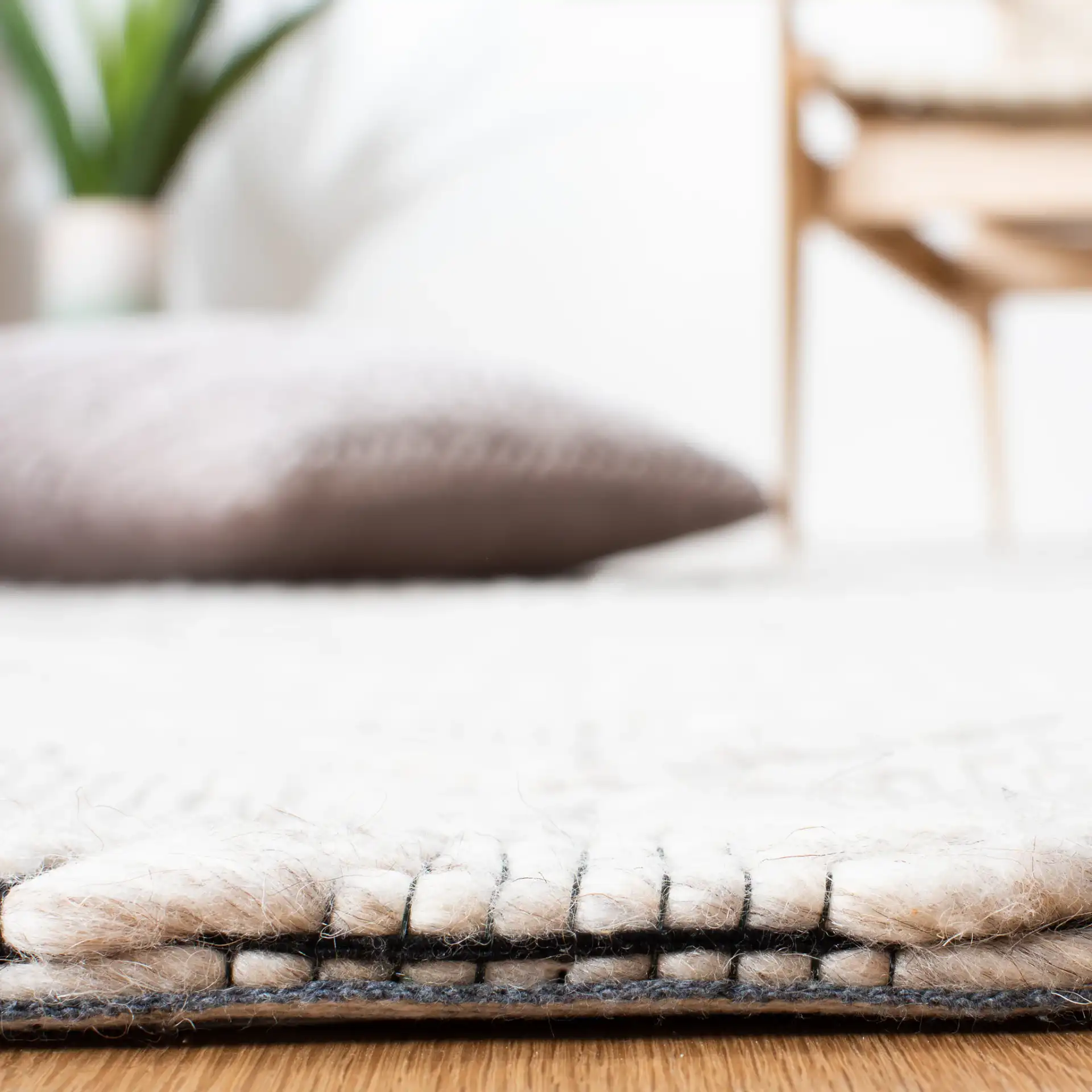 Marbella Banded Diamond Hand-Woven Wool Rug in Silver / Black in a styled room
