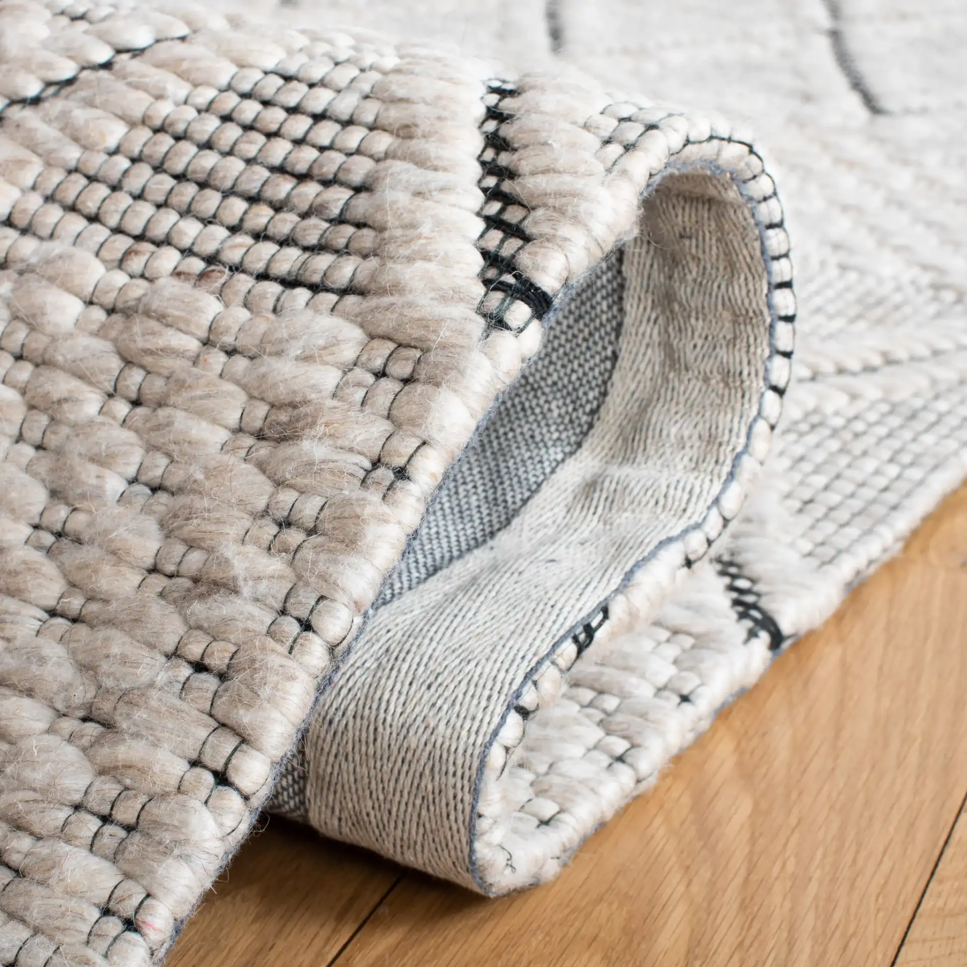 Marbella Banded Diamond Hand-Woven Wool Rug in Silver / Black in a styled room