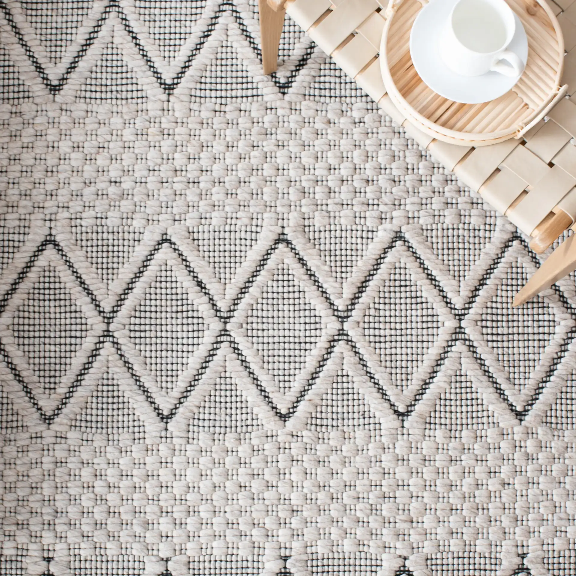 Marbella Banded Diamond Hand-Woven Wool Rug in Silver / Black in a styled room