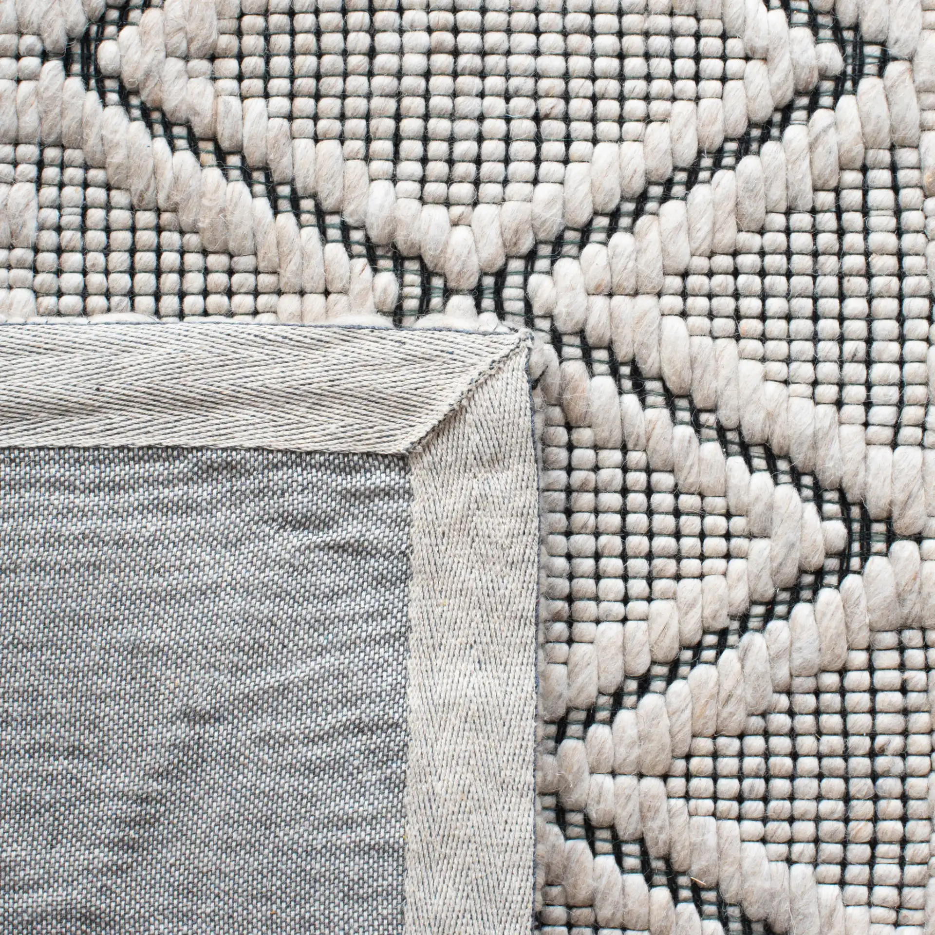 Marbella Banded Diamond Hand-Woven Wool Rug in Silver / Black in a styled room