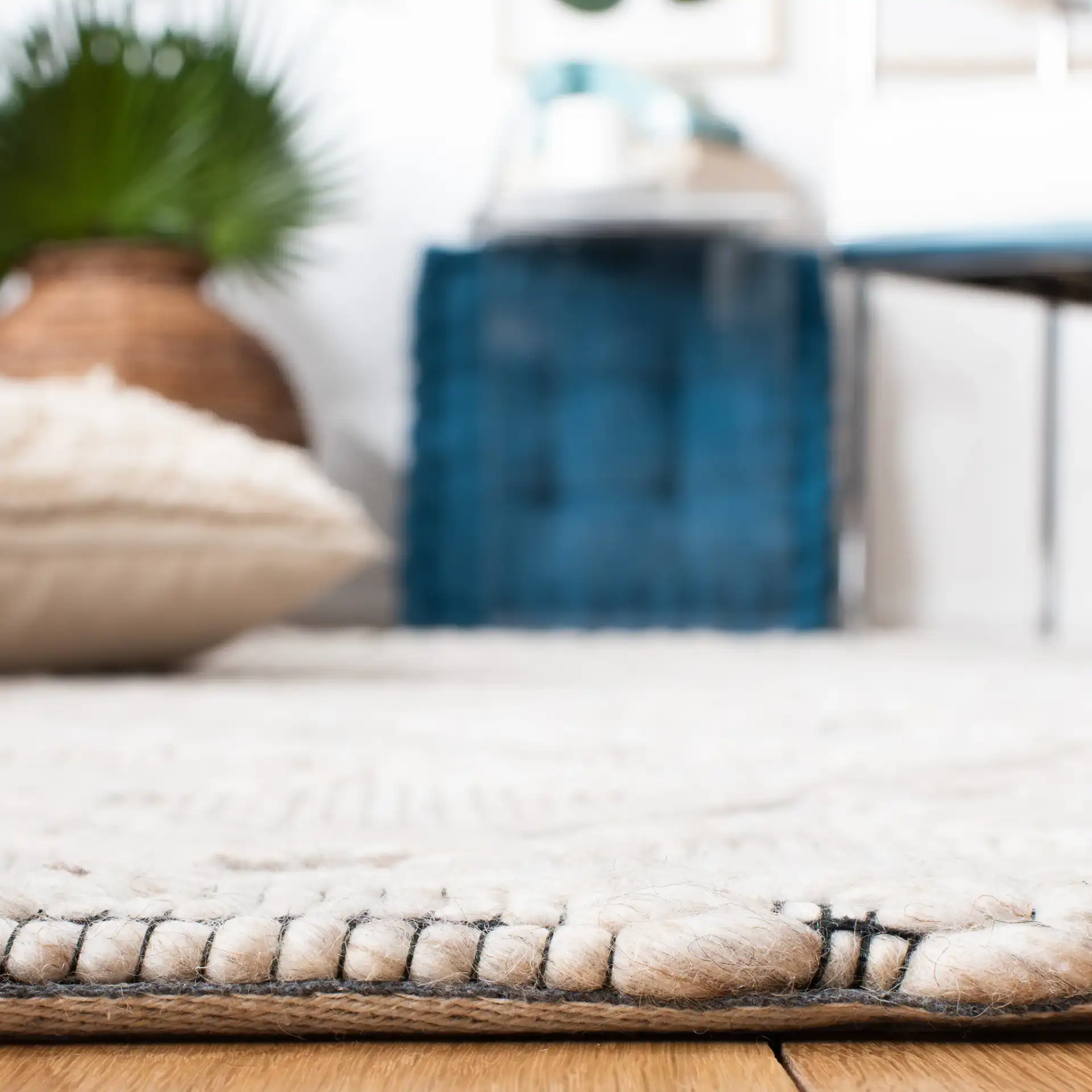 Marbella Diamond Trellis Hand-Woven Wool Rug in Silver / Black in a styled room