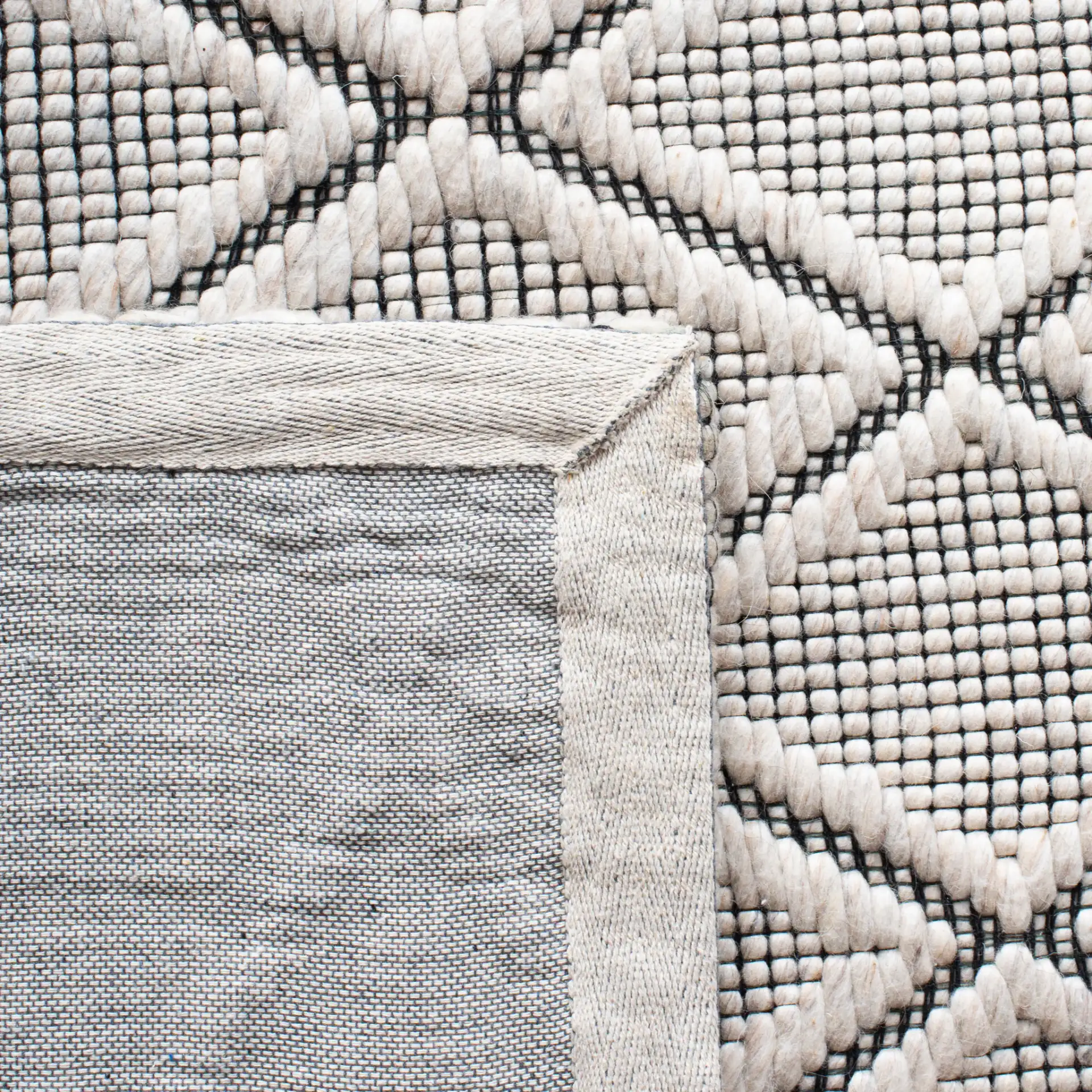 Marbella Diamond Trellis Hand-Woven Wool Rug in Silver / Black in a styled room