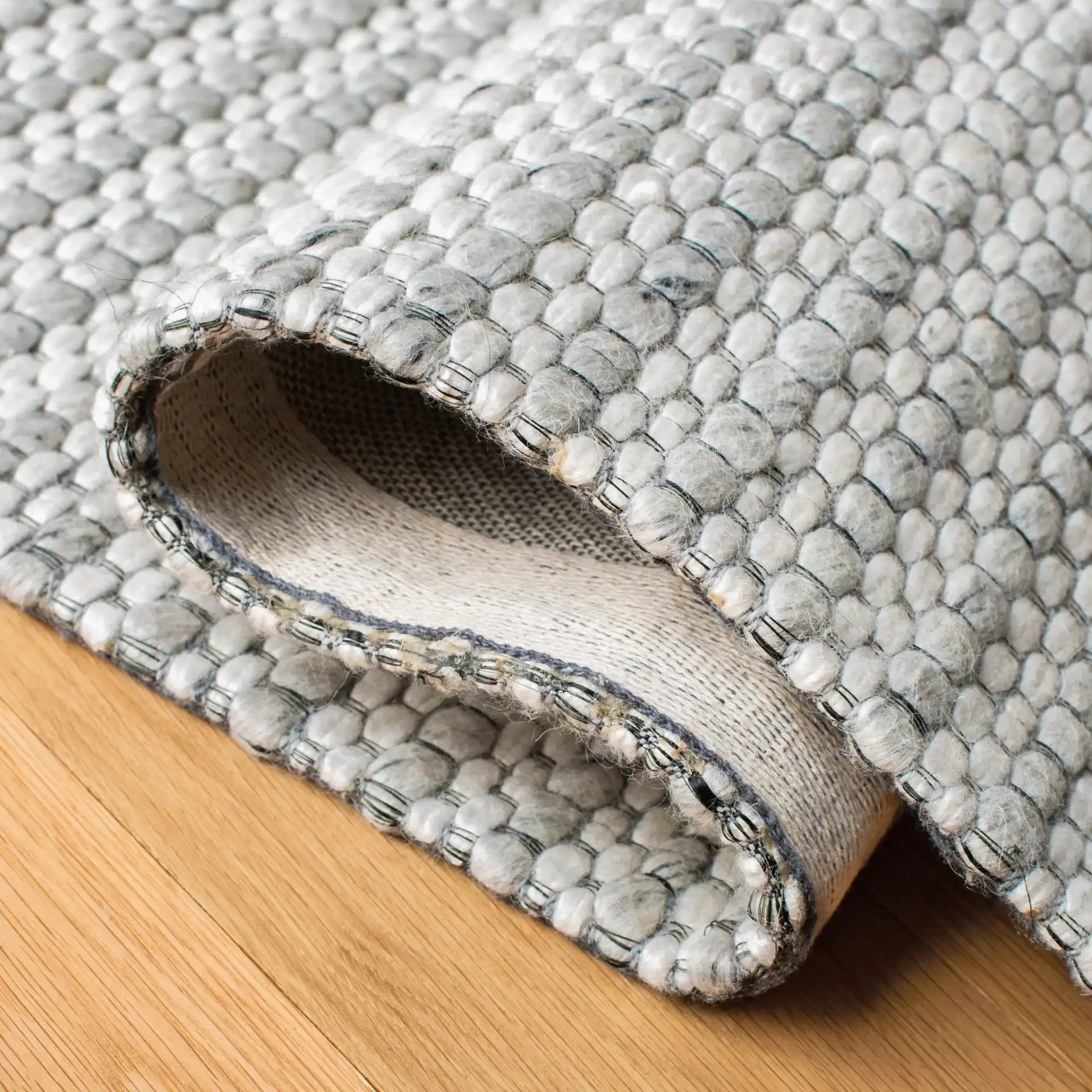Marbella Textured Solid Flatweave Wool Rug in Light Gray / Ivory in a styled room