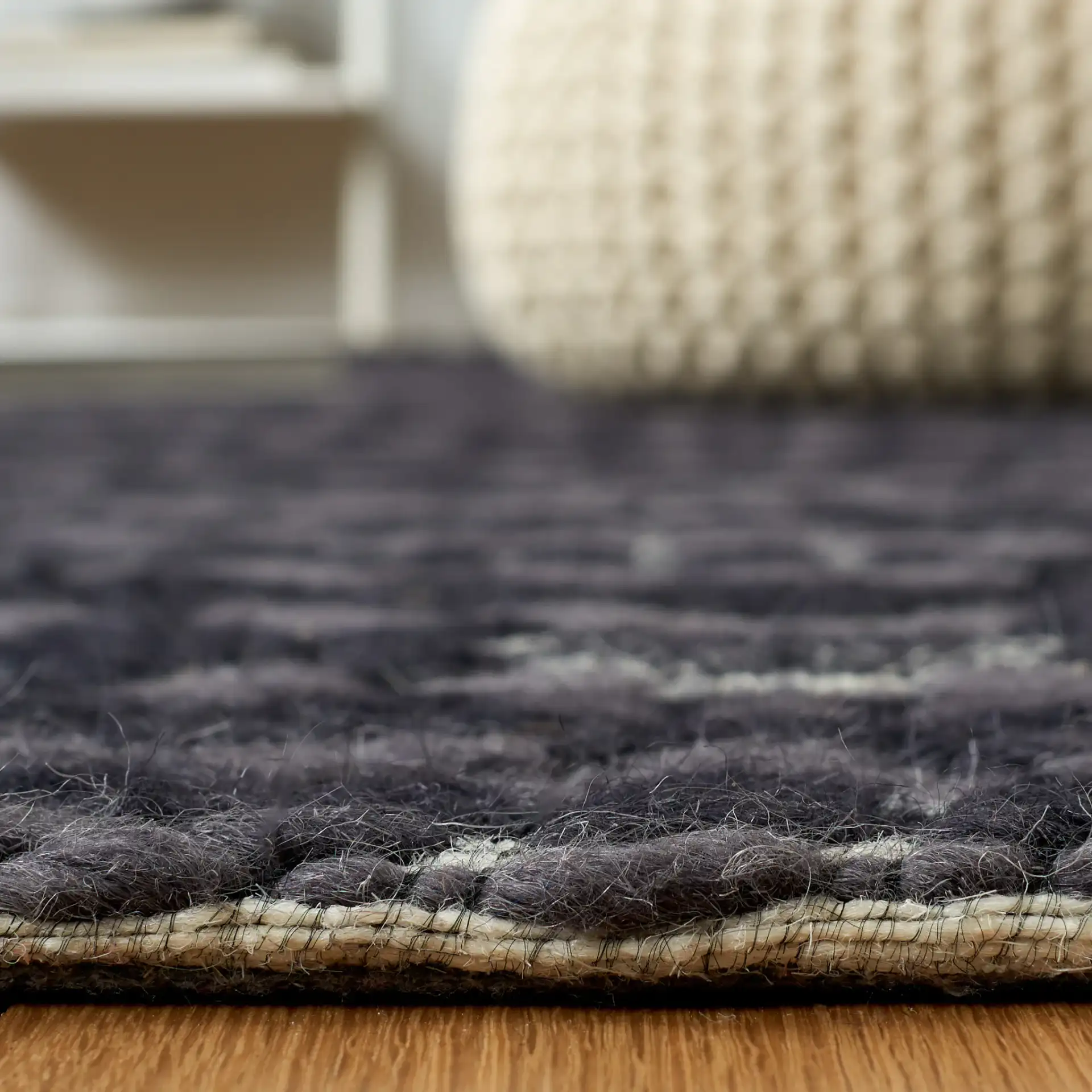 Marbella Hampshire Concentric Diamond Hand-Loomed Wool Rug in Black / Ivory in a styled room