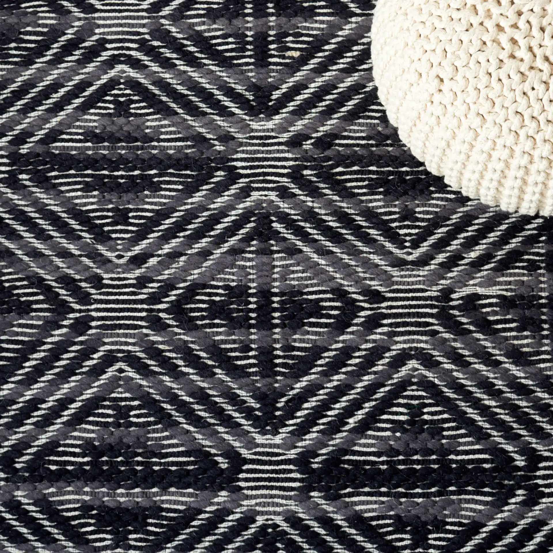 Marbella Hampshire Concentric Diamond Hand-Loomed Wool Rug in Black / Ivory in a styled room