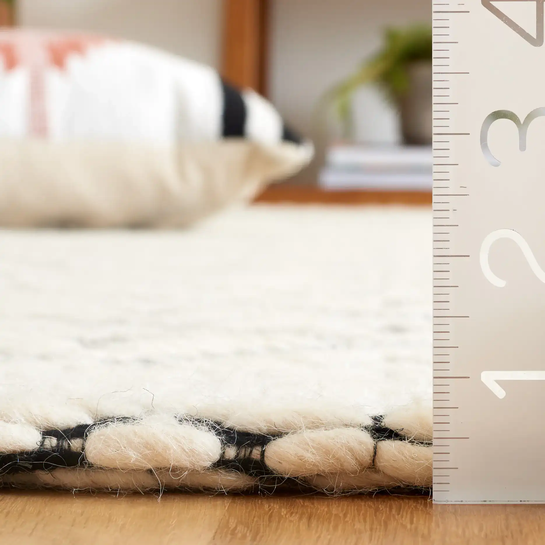 Marbella Kenza Diamond Lattice Hand-Loomed Wool Rug in Black / Ivory in a styled room