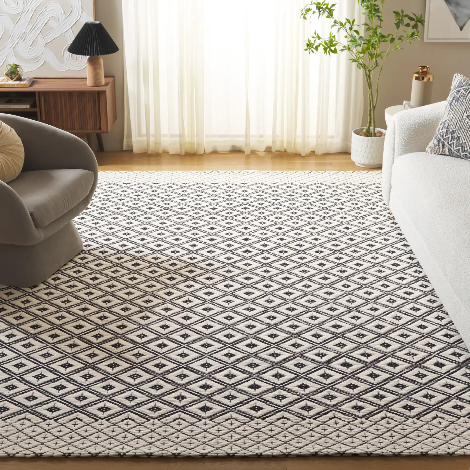 Marbella Kenza Diamond Lattice Hand-Loomed Wool Rug in Black / Ivory in a styled room