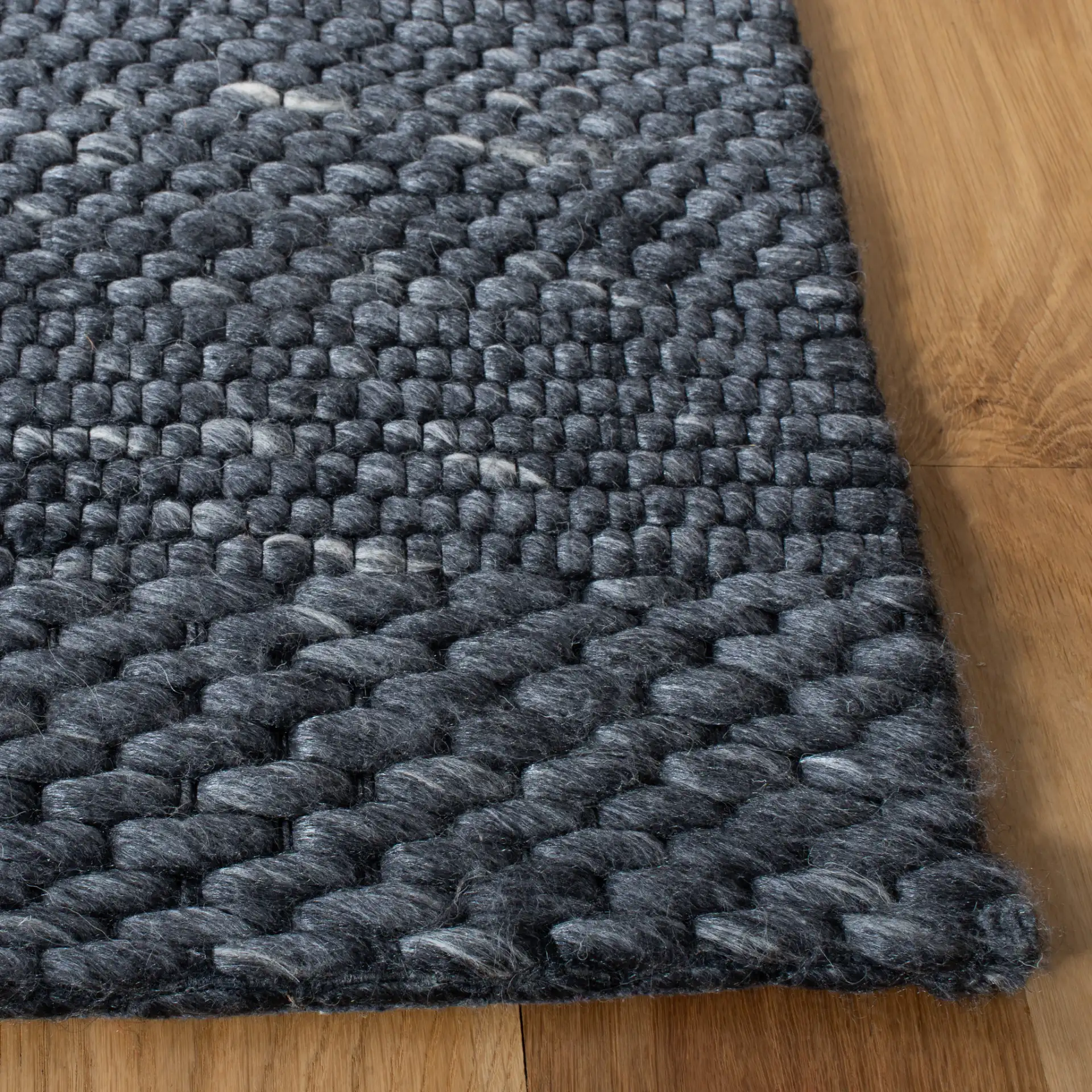 Marbella Speckled Ribbed Hand-Loomed Rug in Charcoal in a styled room