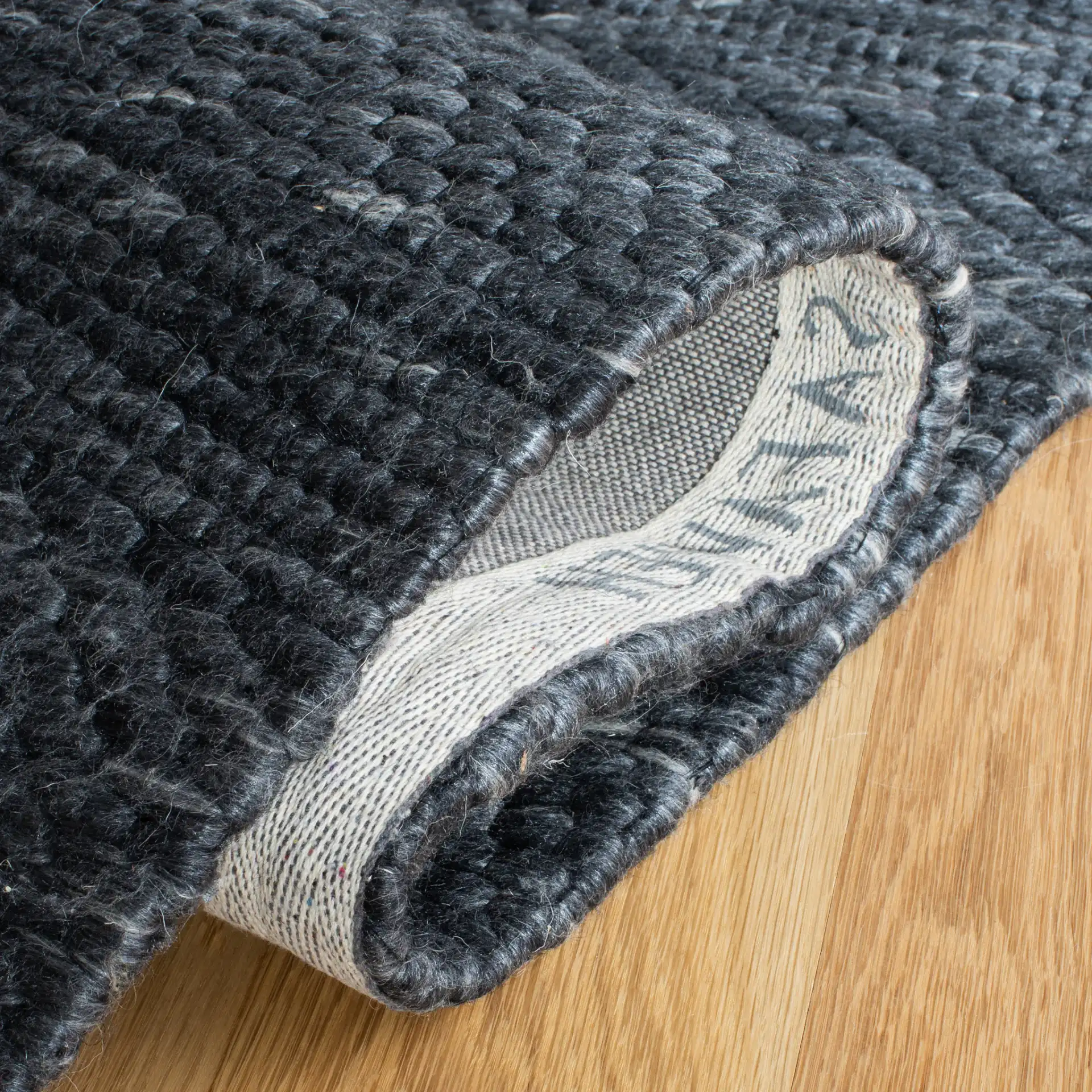 Marbella Speckled Ribbed Hand-Loomed Rug in Charcoal in a styled room