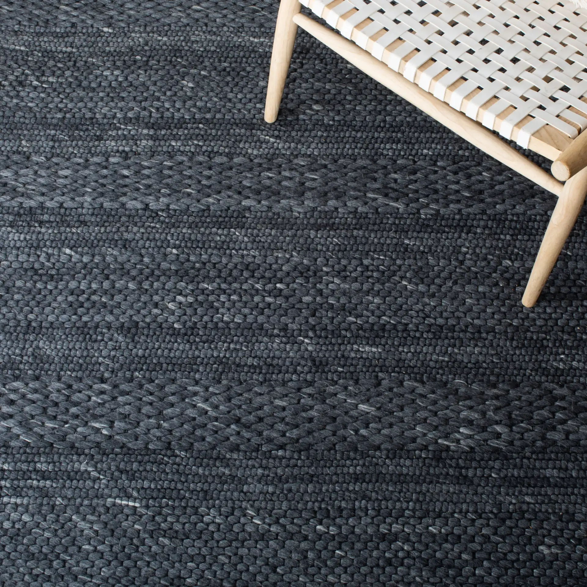 Marbella Speckled Ribbed Hand-Loomed Rug in Charcoal in a styled room
