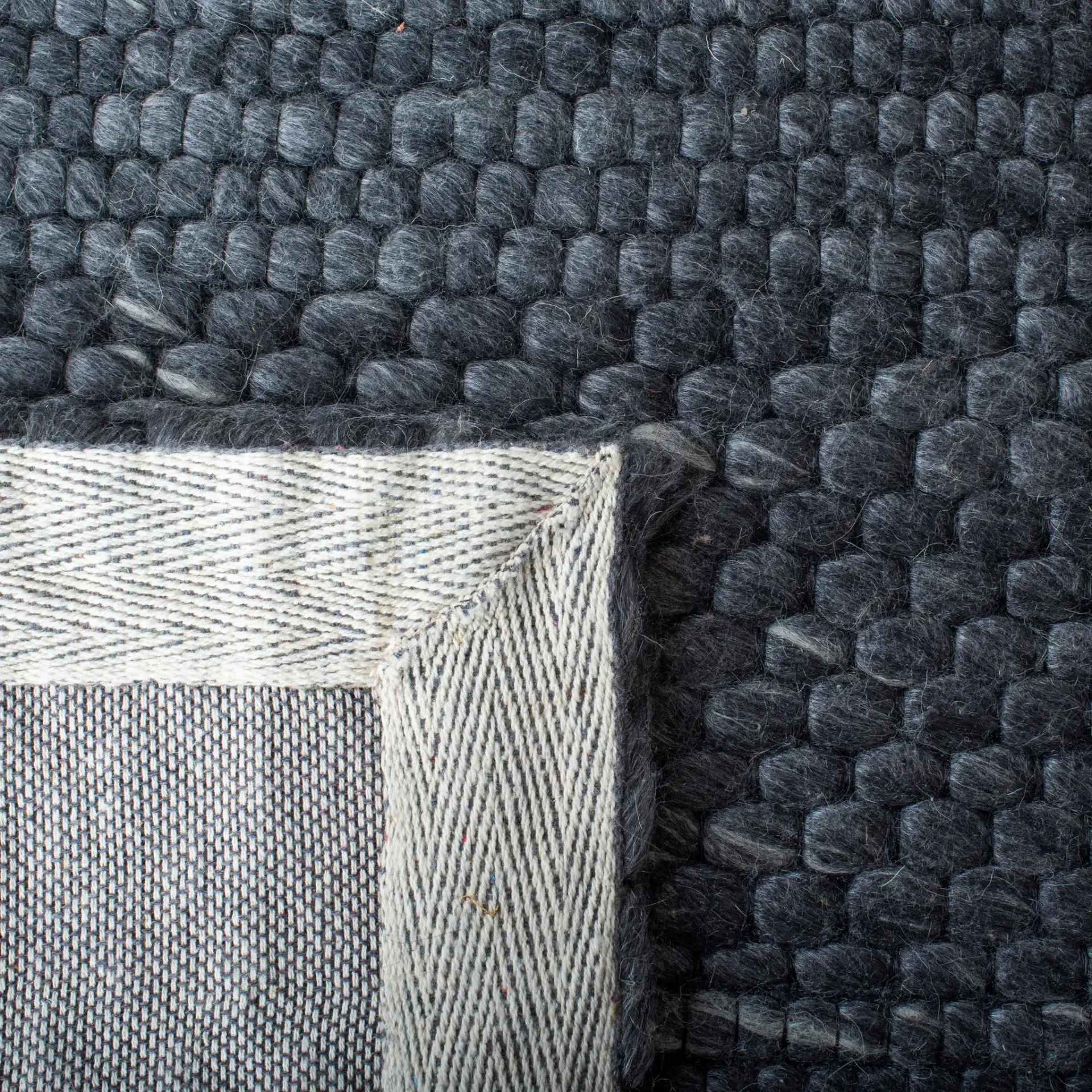 Marbella Speckled Ribbed Hand-Loomed Rug in Charcoal in a styled room
