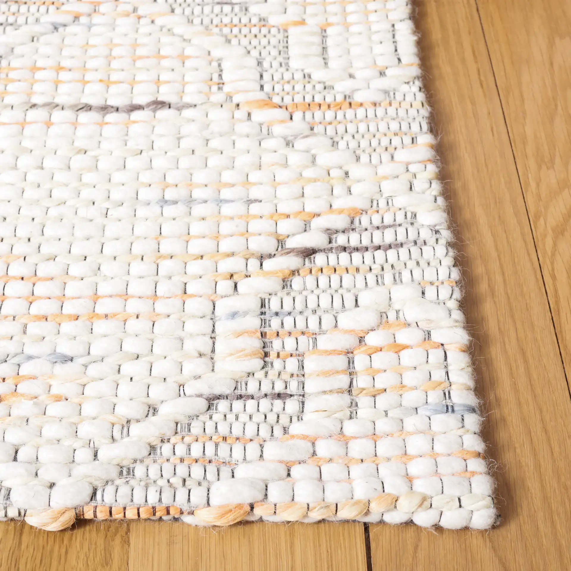 Marbella Ogee Trellis Hand-Loomed Rug in Ivory / Orange in a styled room