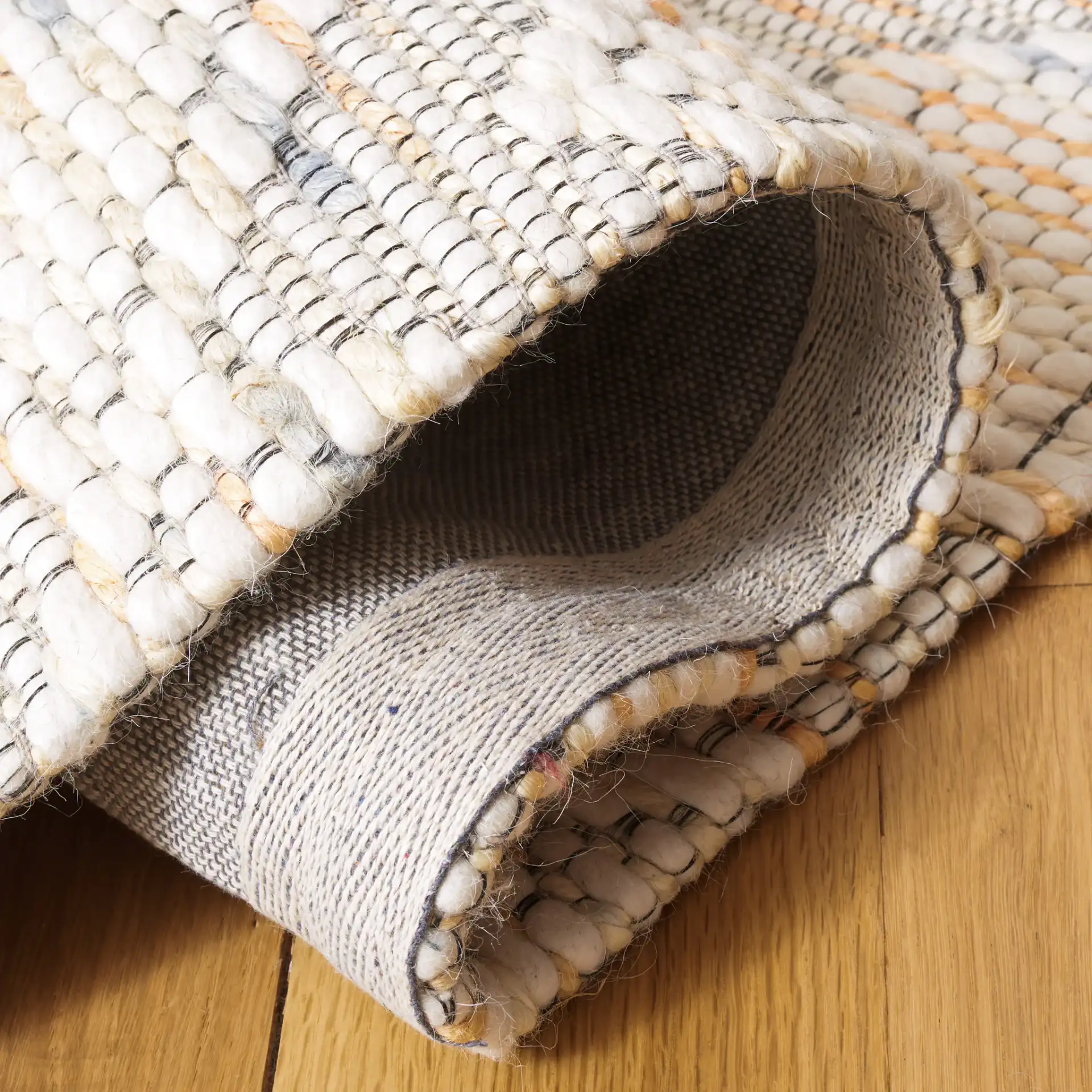 Marbella Ogee Trellis Hand-Loomed Rug in Ivory / Orange in a styled room