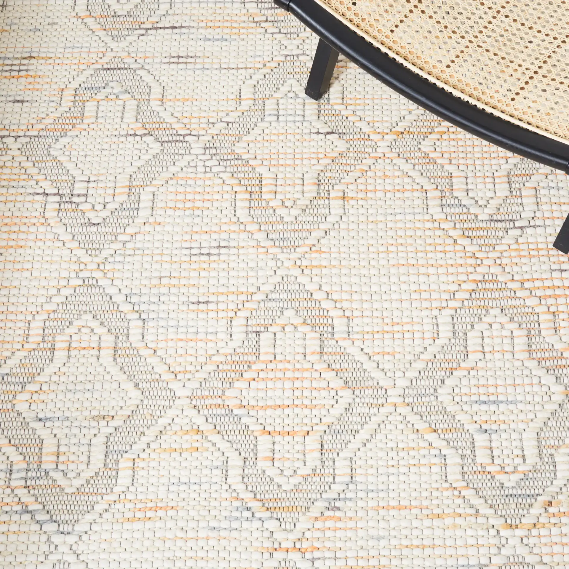 Marbella Ogee Trellis Hand-Loomed Rug in Ivory / Orange in a styled room