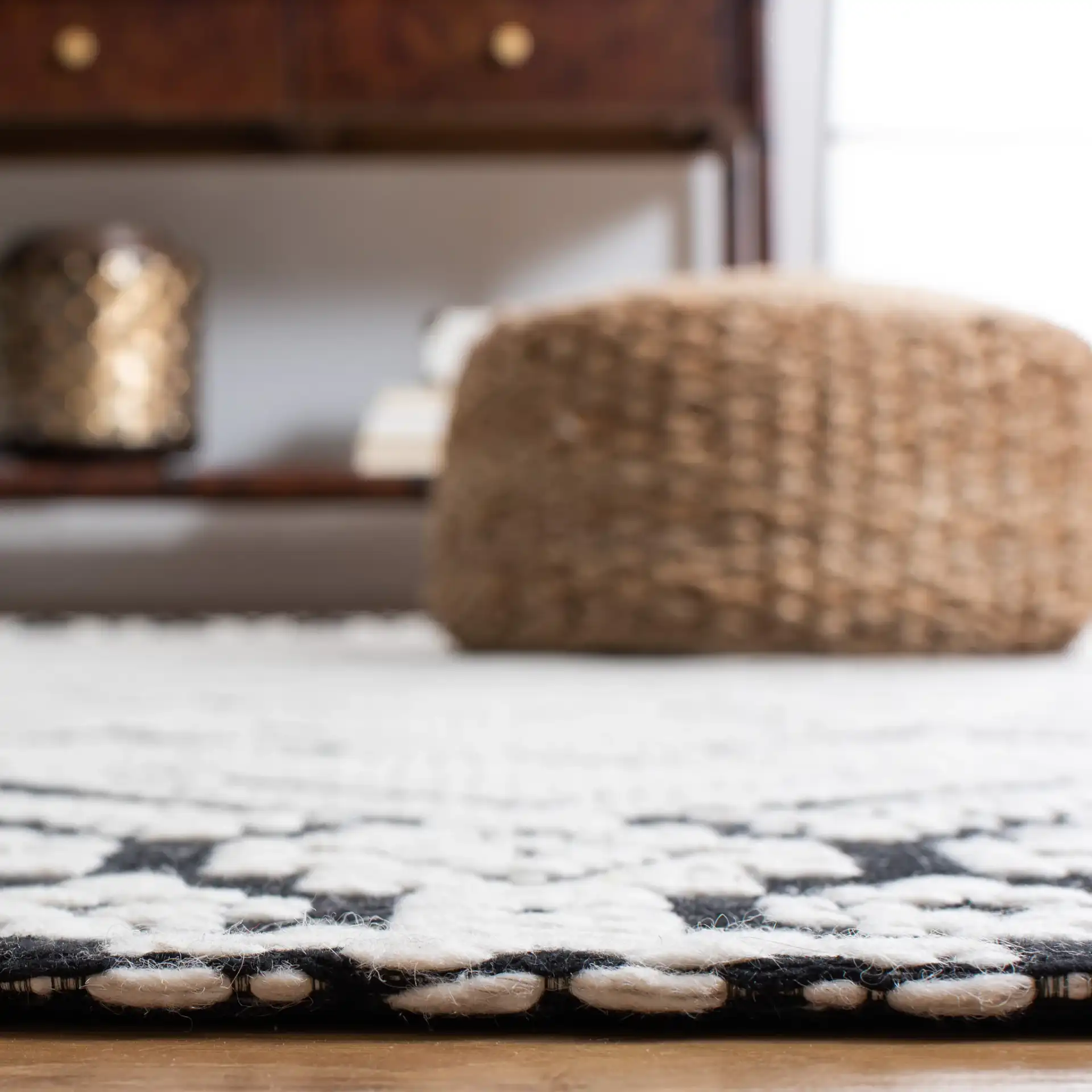 Marbella Diamond Border Hand-Woven Wool Rug in Ivory / Black in a styled room