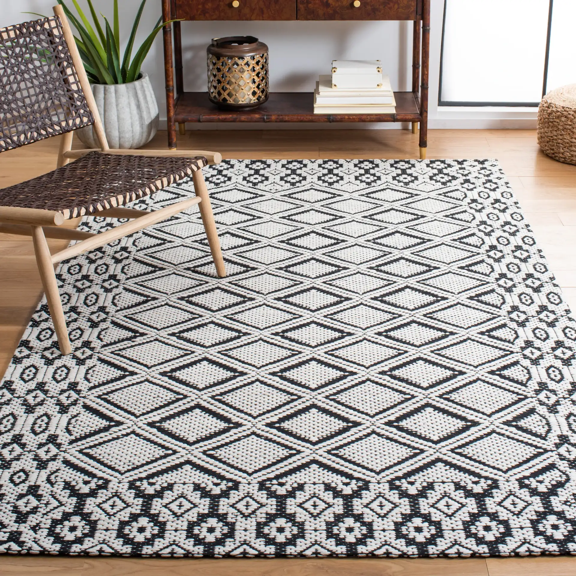 Marbella Diamond Border Hand-Woven Wool Rug in Ivory / Black in a styled room