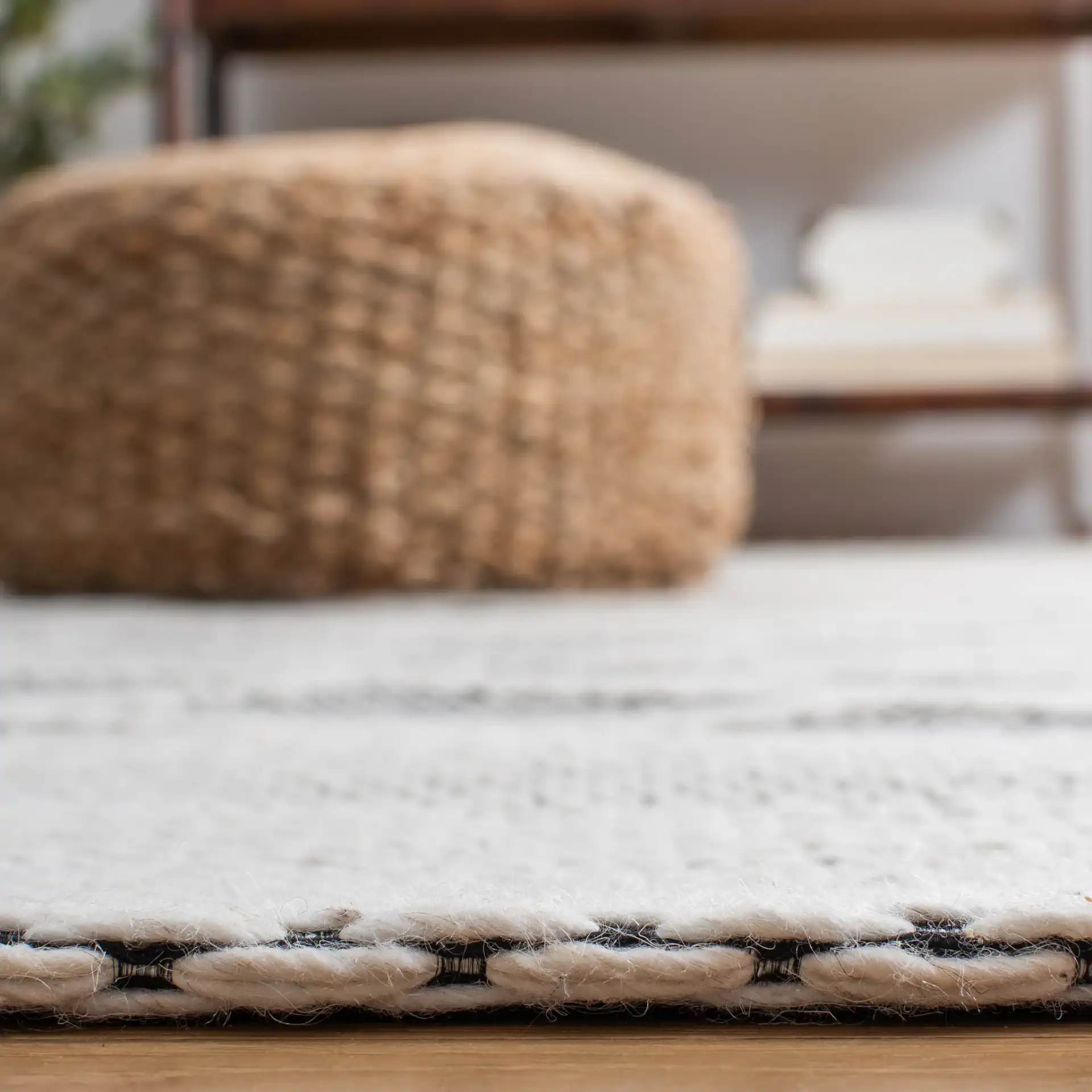 Marbella Banded Diamond Lattice Hand-Woven Wool Rug in Ivory / Black in a styled room